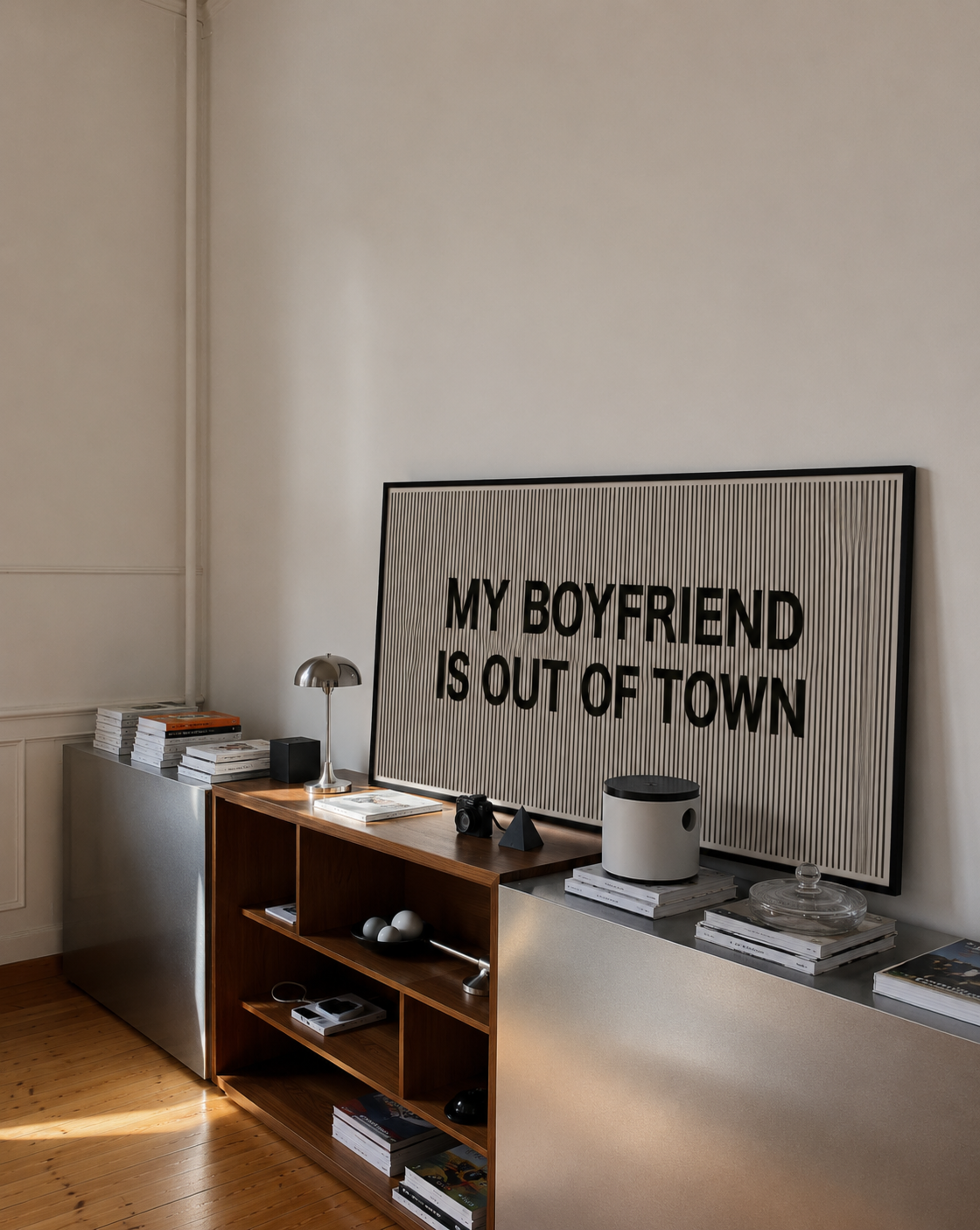 Framed artwork with text 'My Boyfriend is Out of Town' on a wall in a room.