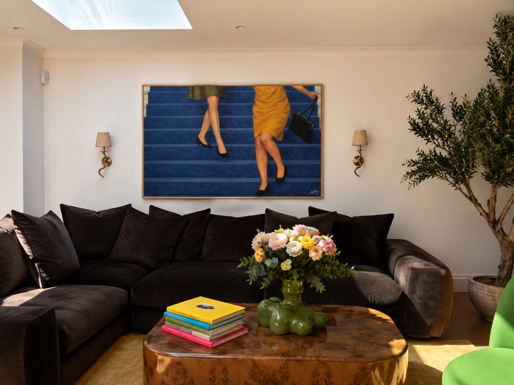 The Blue Staircase is a hand painted Contemporary and figurative wall art of two women descending deep blue stairs, inspired by European cinema and nostalgic mid century aesthetics, against a blue background with expressive painterly texture. Minimalist Feminine Mid century modern oil painting in cinematic nostalgia composition.
