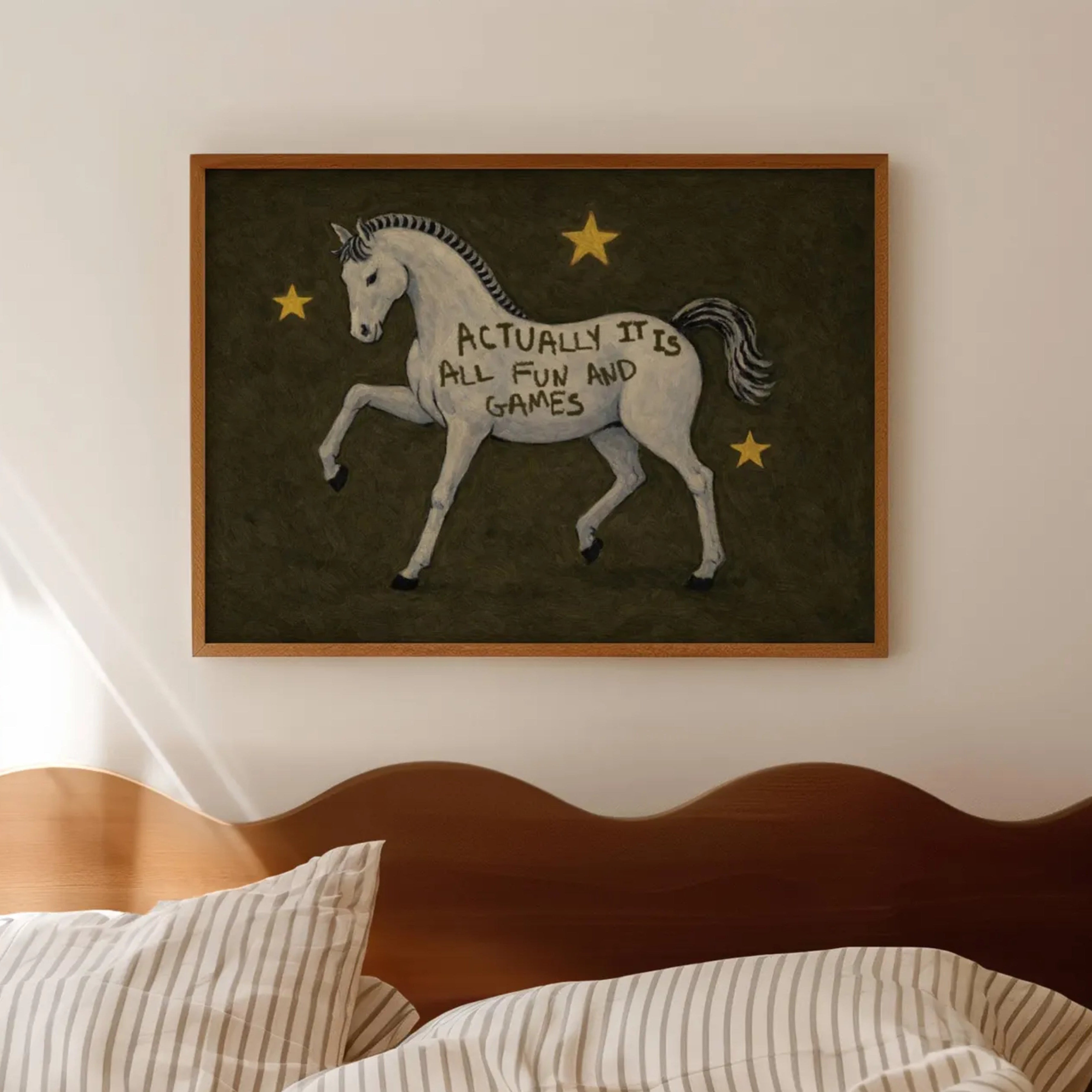 A surreal Symbolic artwork featuring a White Horse running against a khaki background with stars. The Horse has handwritten quote "Actually It Is All Fun and Games". This is a hand drawn Contemporary Folk art Print Oil Painting.