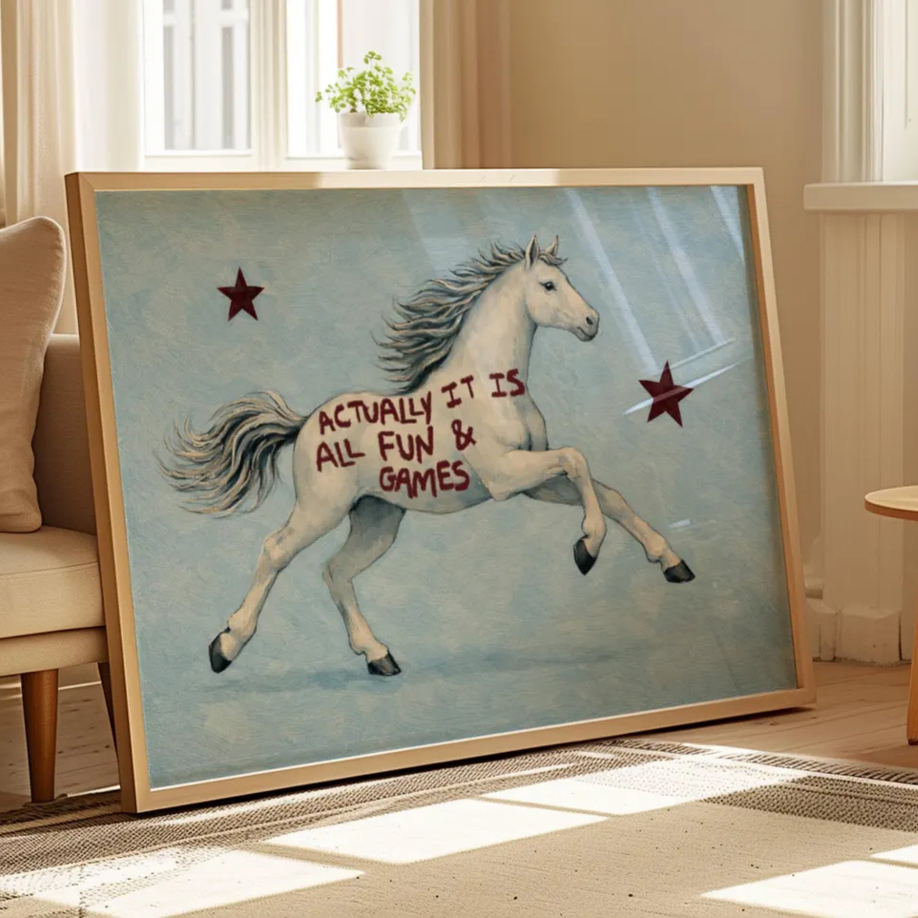 A surreal Symbolic artwork featuring a White Horse running against a pale blue background with Burgundy stars. The Horse has handwritten quote "Actually It Is All Fun and Games". This is a hand drawn Contemporary Folk art Print Oil Painting.
