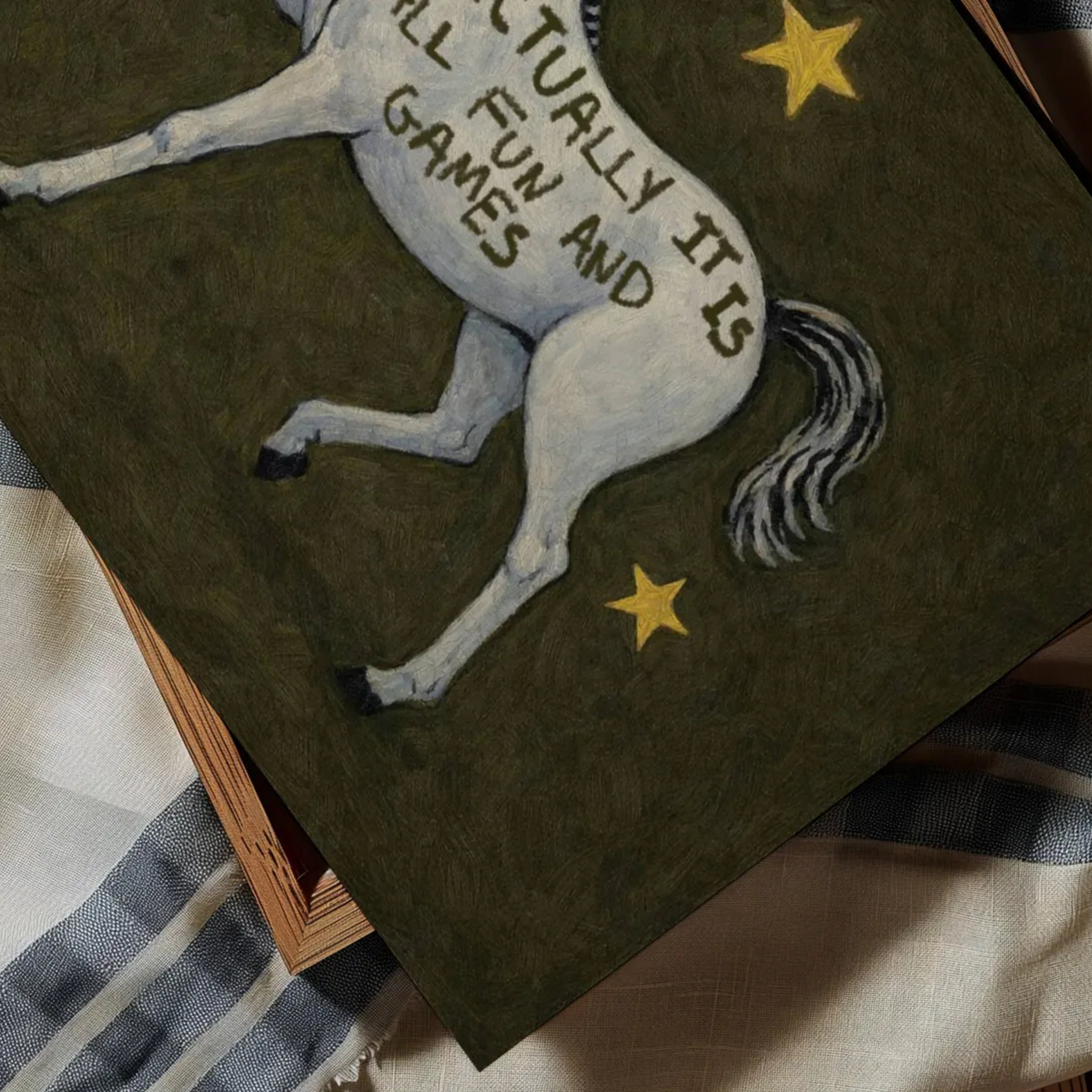 A surreal Symbolic artwork featuring a White Horse running against a khaki background with stars. The Horse has handwritten quote "Actually It Is All Fun and Games". This is a hand drawn Contemporary Folk art Print Oil Painting.