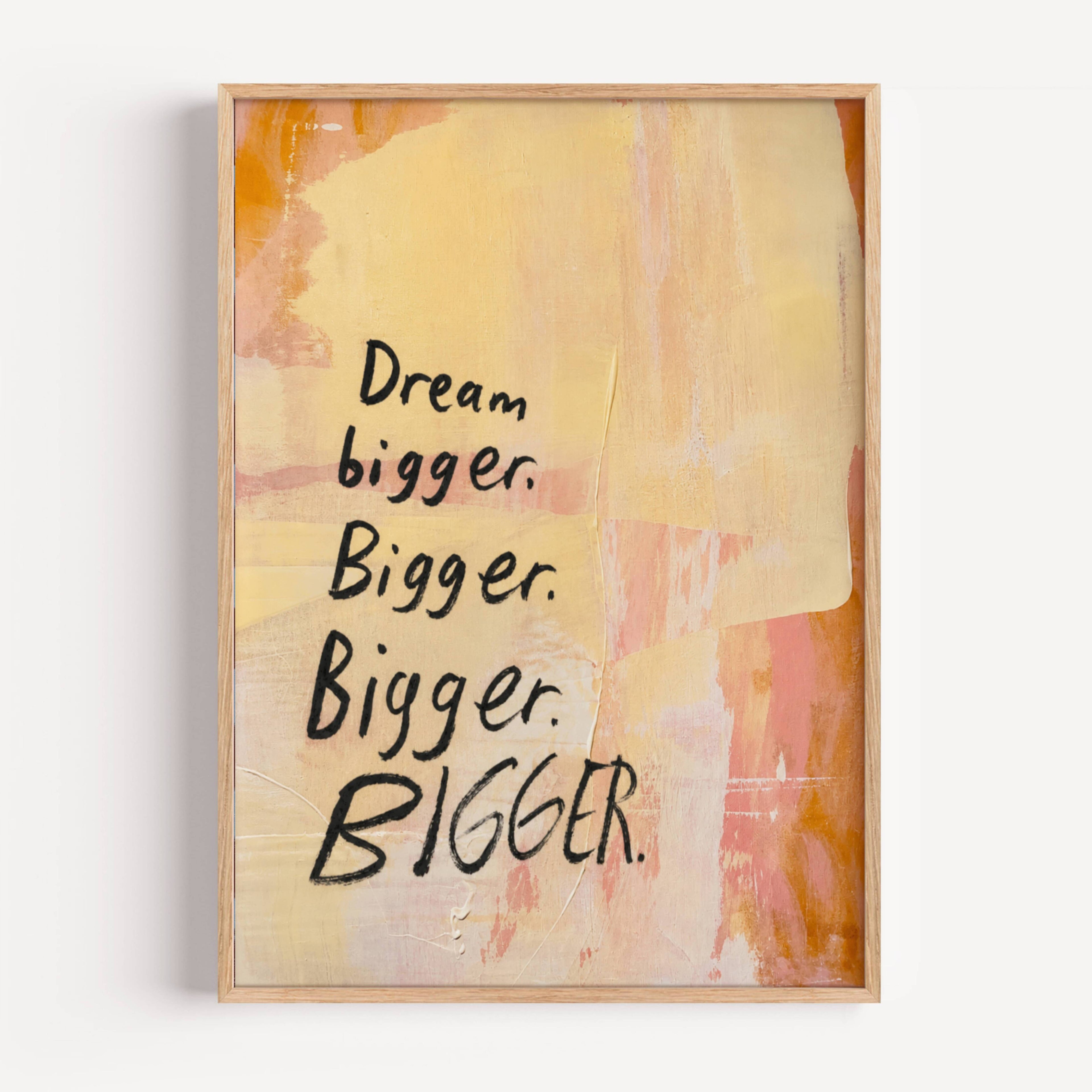Framed artwork with 'Dream bigger. Bigger. Bigger. BIGGER.' text on a colorful abstract background.