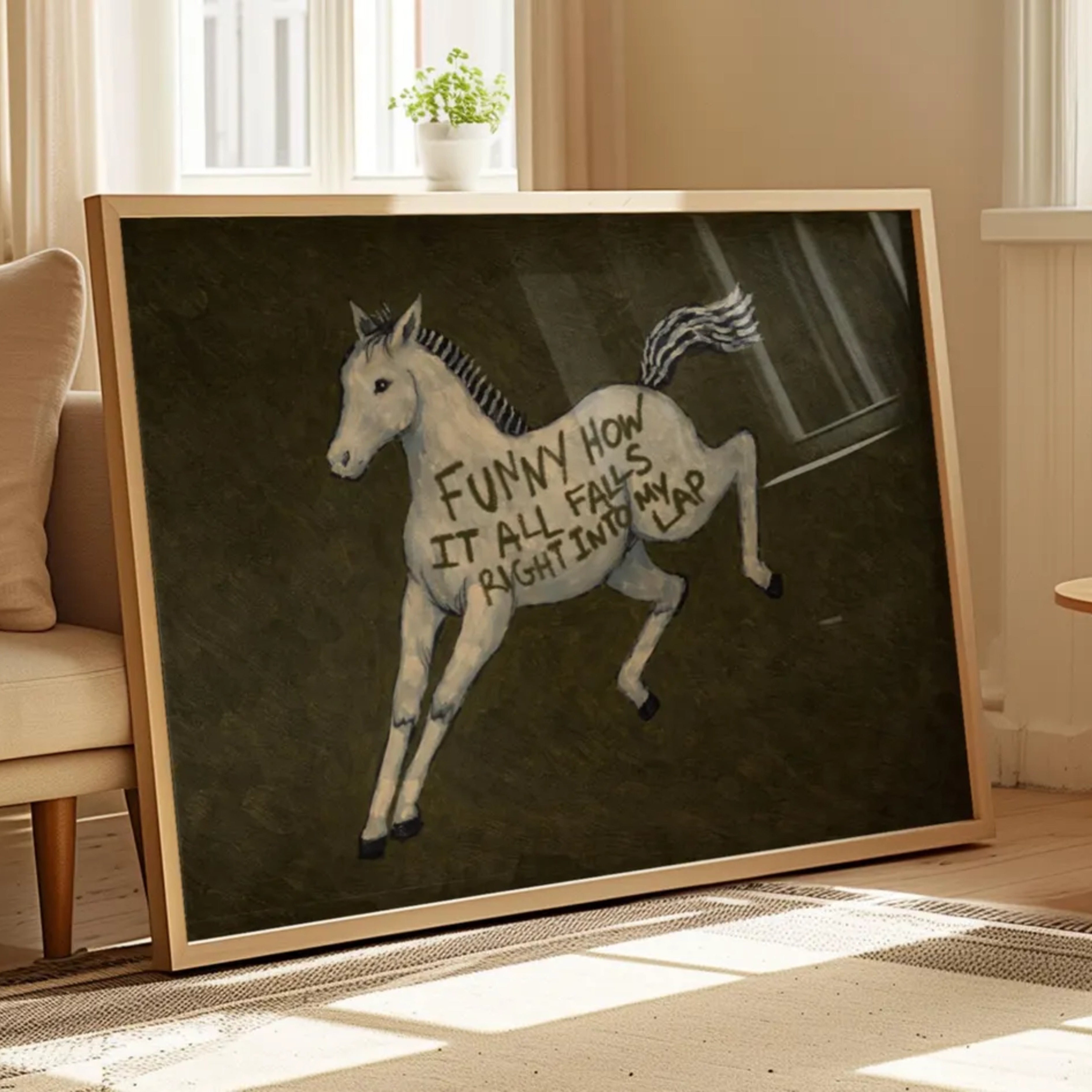 A surreal Symbolic artwork featuring a White Horse running against a deep khaki green background. The Horse has handwritten quote "Funny How It All Falls Right Into my Lap". This is a hand drawn Contemporary Folk art Print Oil Painting.