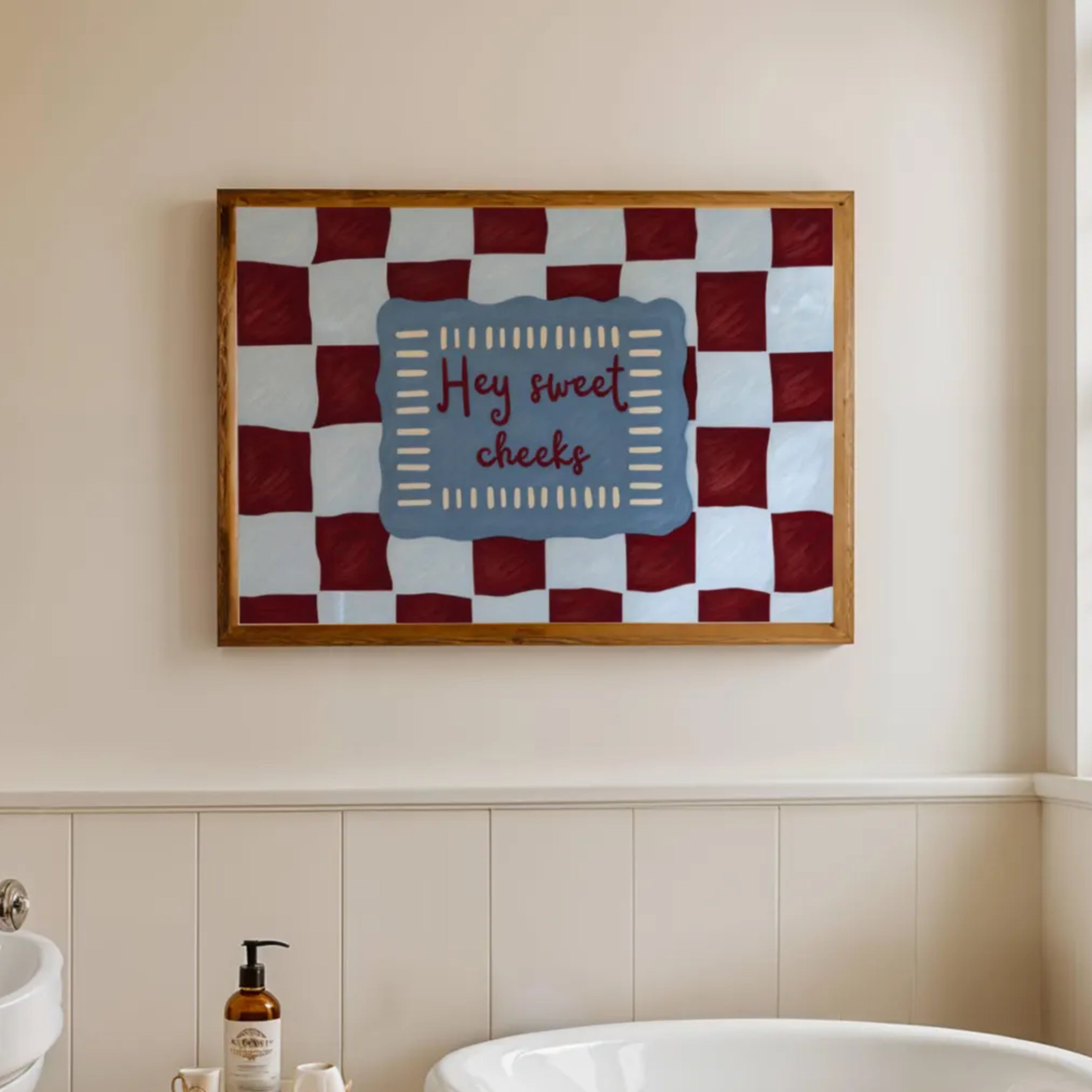 HEY SWEET CHEEKS is a whimsical Retro typography art print designed to bring humour, colour and personality into your bathroom and laundry room. Featuring vintage-inspired Checkered patterns and hand-lettered typography, this artwork captures the nostalgic charm while adding a playful decorative touch to modern interiors. this is a hand drawn Retro quote wall art, ideal for bathrooms, laundry room decor, and cheeky playful interiors. blue burgundy