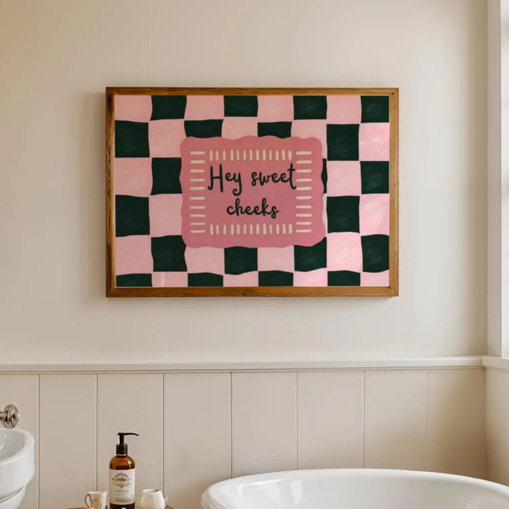 HEY SWEET CHEEKS is a whimsical Retro typography art print designed to bring humour, colour and personality into your bathroom and laundry room. Featuring vintage-inspired Checkered patterns and hand-lettered typography, this artwork captures the nostalgic charm while adding a playful decorative touch to modern interiors. this is a hand drawn Retro quote wall art, ideal for bathrooms, laundry room decor, and cheeky playful interiors. pink green