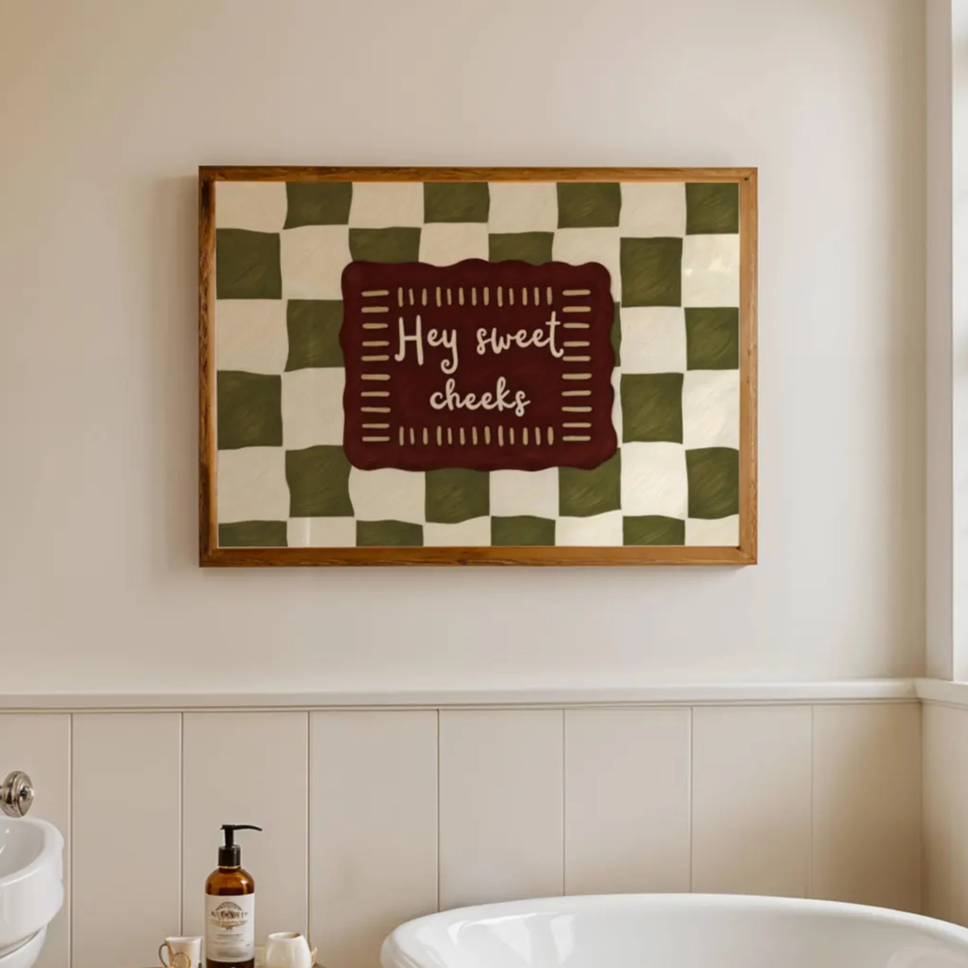 HEY SWEET CHEEKS is a whimsical Retro typography art print designed to bring humour, colour and personality into your bathroom and laundry room. Featuring vintage-inspired Checkered patterns and hand-lettered typography, this artwork captures the nostalgic charm while adding a playful decorative touch to modern interiors. this is a hand drawn Retro quote wall art, ideal for bathrooms, laundry room decor, and cheeky playful interiors. khaki burgundy
