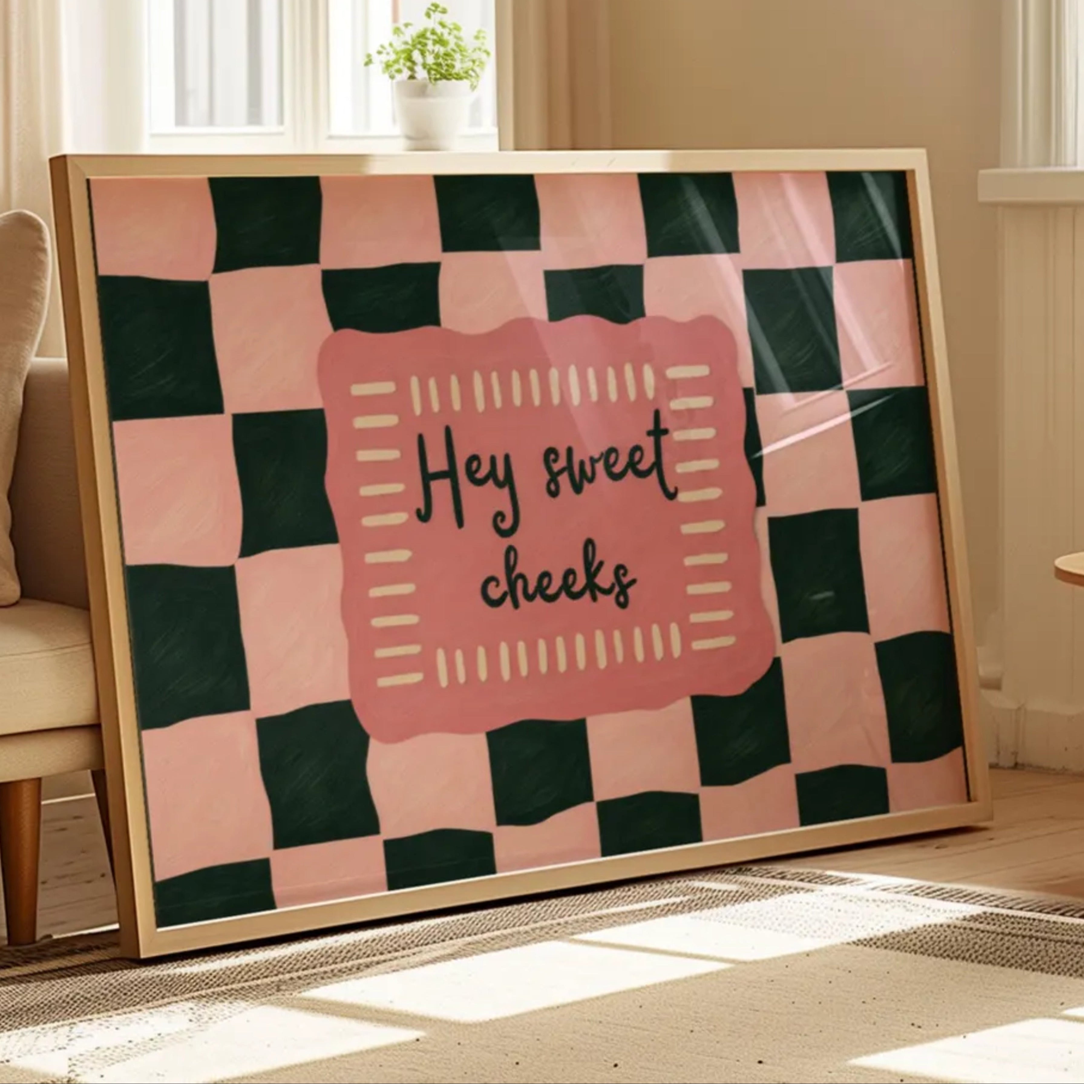 HEY SWEET CHEEKS is a whimsical Retro typography art print designed to bring humour, colour and personality into your bathroom and laundry room. Featuring vintage-inspired Checkered patterns and hand-lettered typography, this artwork captures the nostalgic charm while adding a playful decorative touch to modern interiors. this is a hand drawn Retro quote wall art, ideal for bathrooms, laundry room decor, and cheeky playful interiors. pink green