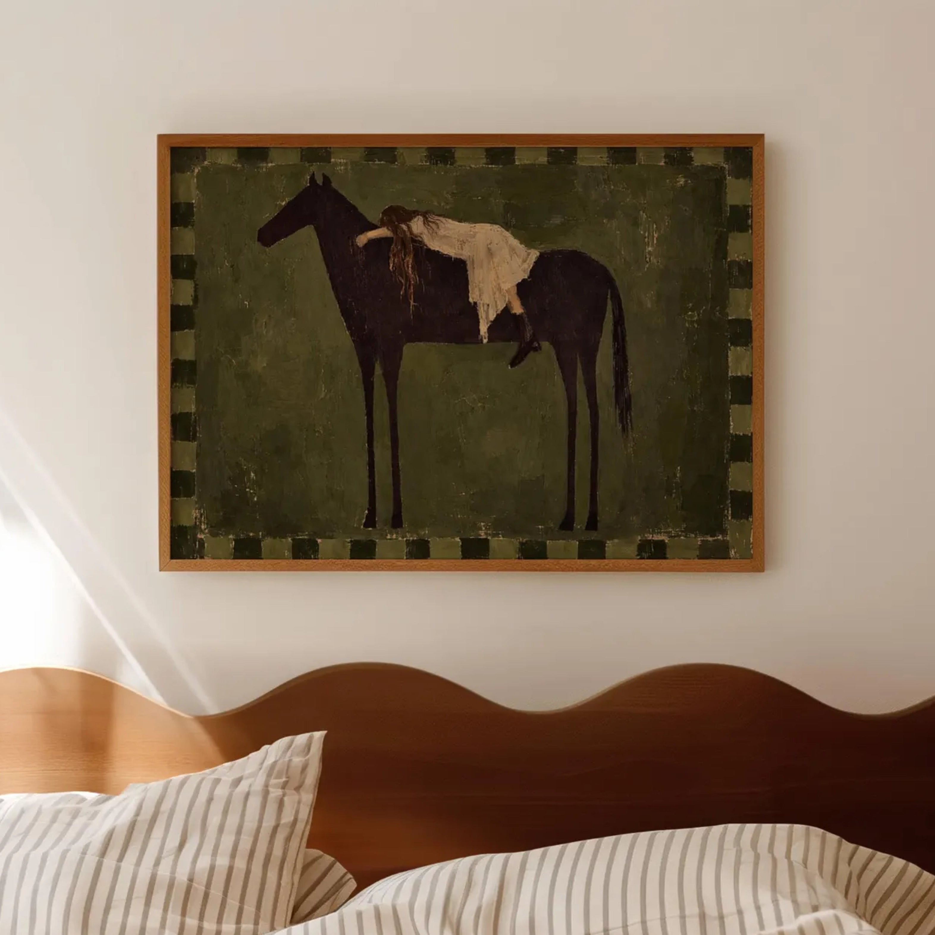 Held by the Horse is a symbolic Western Horse Artwork featuring a restiing female figure on a dark horse in earthy khaki tones