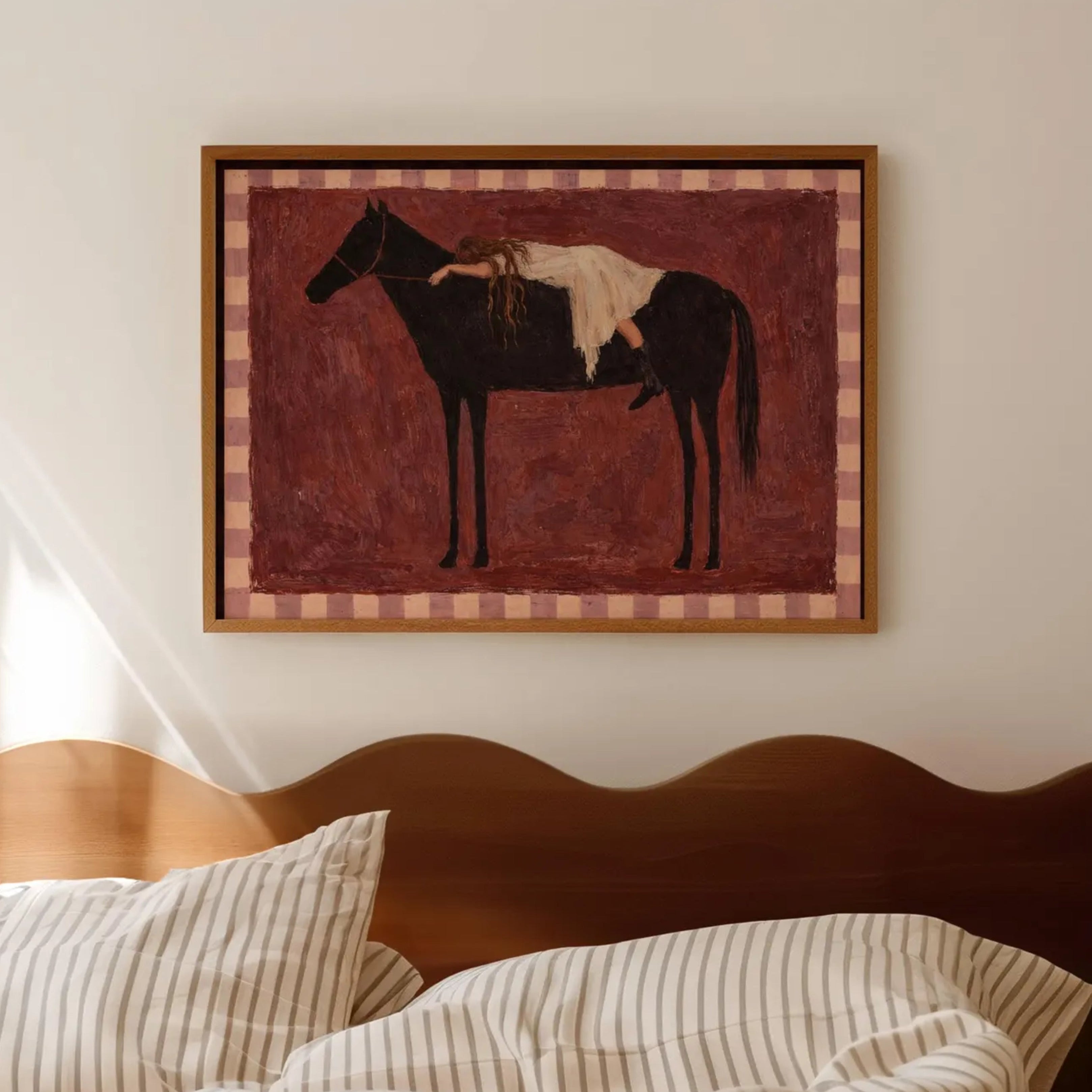 Held by the Horse is a symbolic Western Horse Artwork featuring a restiing female figure on a dark horse in Ruby Burgundy tones