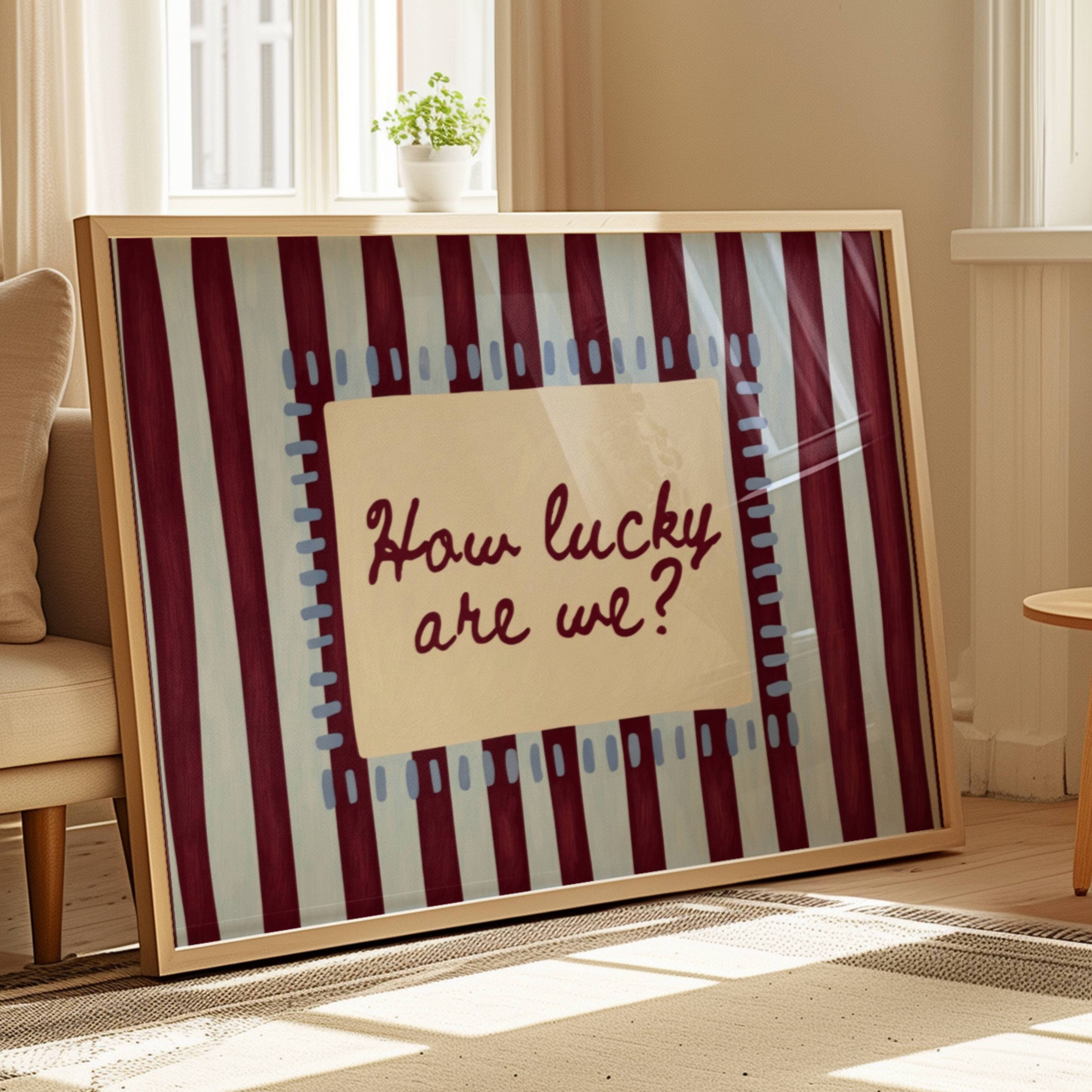 hand drawn Playful typography print with the phrase "How Lucky Are We?" on a blue and ruby burgundy striped background. This is a hand drawn trendy typography wall art print ideal for bedrooms, dorm room decor, gallery walls and playful interiors.