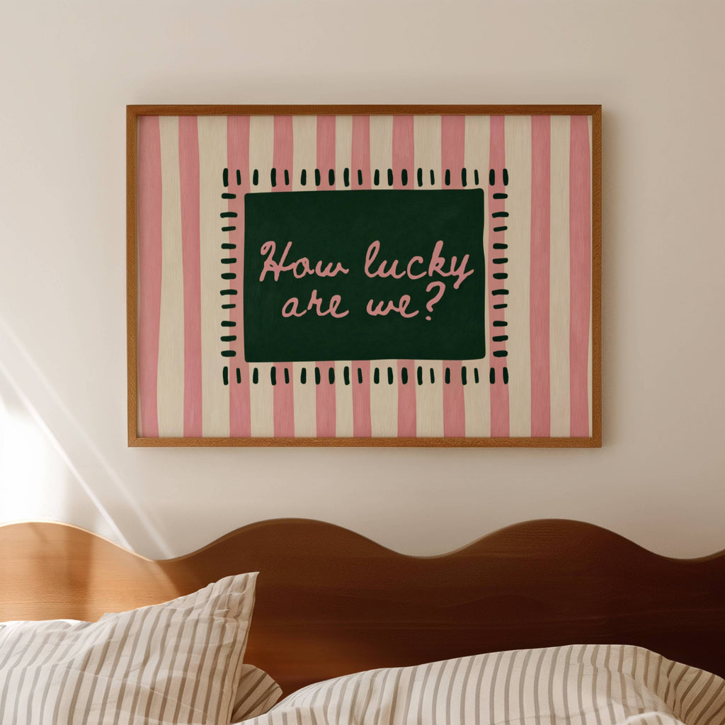 hand drawn Playful typography print with the phrase "How Lucky Are We?" on a pink and green striped background. This is a hand drawn trendy typography wall art print ideal for bedrooms, dorm room decor, gallery walls and playful interiors.