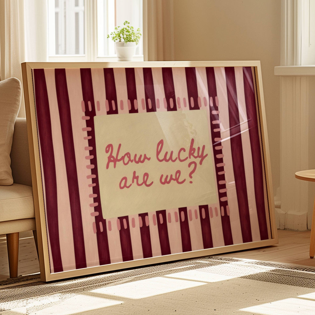 hand drawn Playful typography print with the phrase "How Lucky Are We?" on a pink and ruby burgundy striped background. This is a hand drawn trendy typography wall art print ideal for bedrooms, dorm room decor, gallery walls and playful interiors.