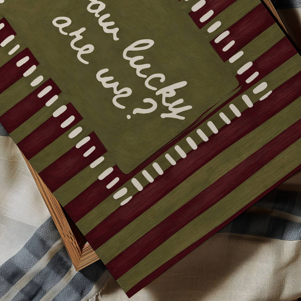 hand drawn Playful typography print with the phrase "How Lucky Are We?" on a khaki and ruby burgundy striped background. This is a hand drawn trendy typography wall art print ideal for bedrooms, dorm room decor, gallery walls and playful interiors.