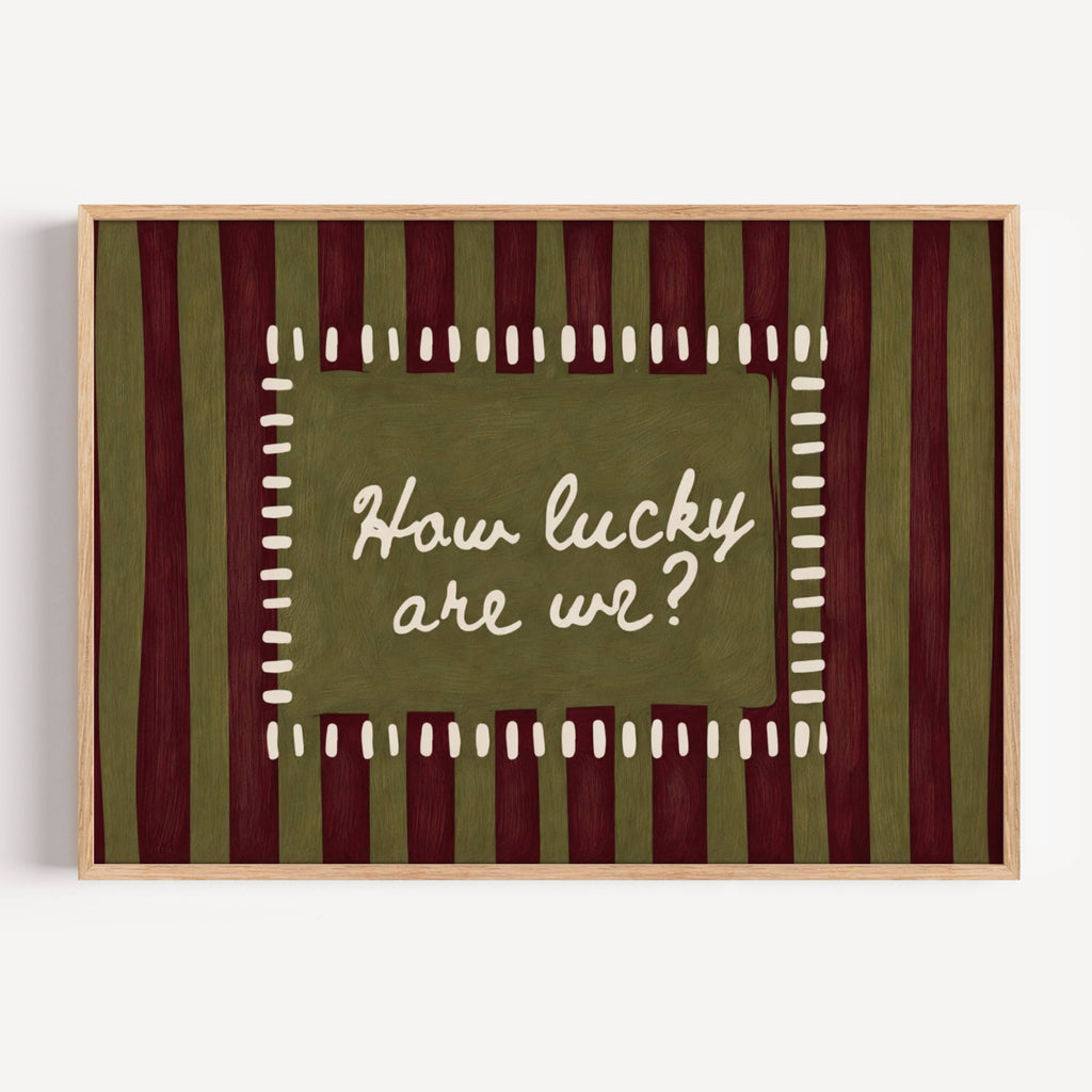 hand drawn Playful typography print with the phrase "How Lucky Are We?" on a khaki and ruby burgundy striped background. This is a hand drawn trendy typography wall art print ideal for bedrooms, dorm room decor, gallery walls and playful interiors.