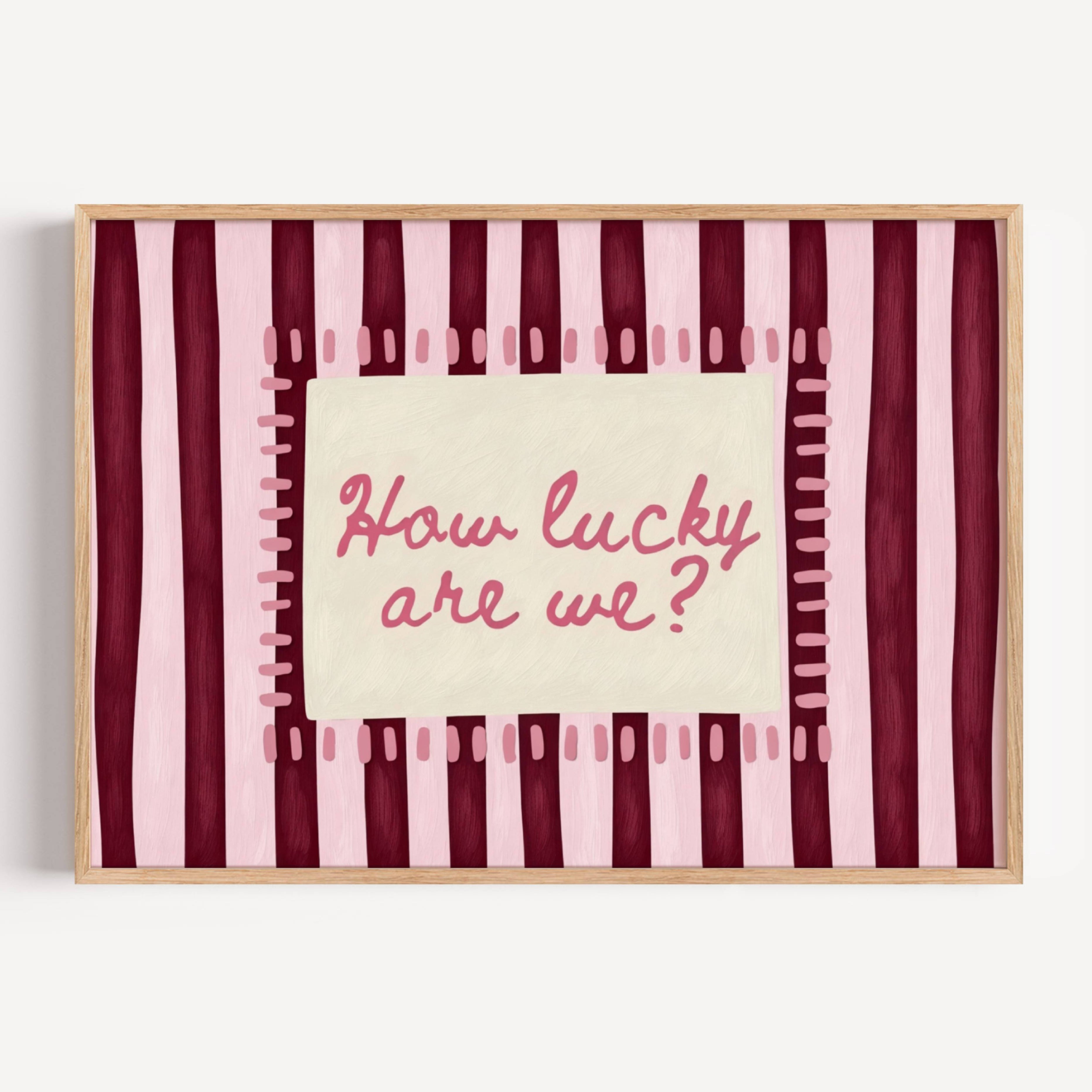 hand drawn Playful typography print with the phrase "How Lucky Are We?" on a pink and ruby burgundy striped background. This is a hand drawn trendy typography wall art print ideal for bedrooms, dorm room decor, gallery walls and playful interiors.