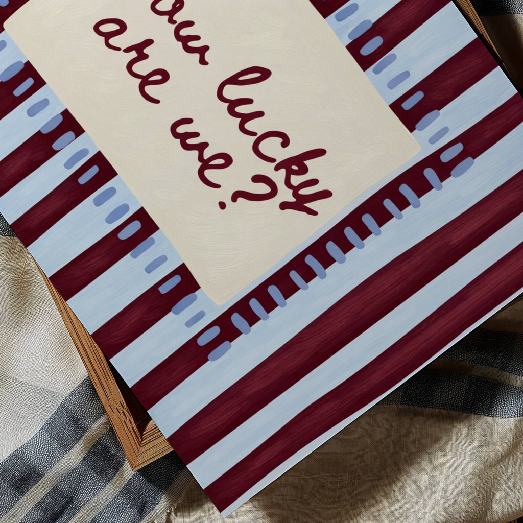 hand drawn Playful typography print with the phrase "How Lucky Are We?" on a blue and ruby burgundy striped background. This is a hand drawn trendy typography wall art print ideal for bedrooms, dorm room decor, gallery walls and playful interiors.