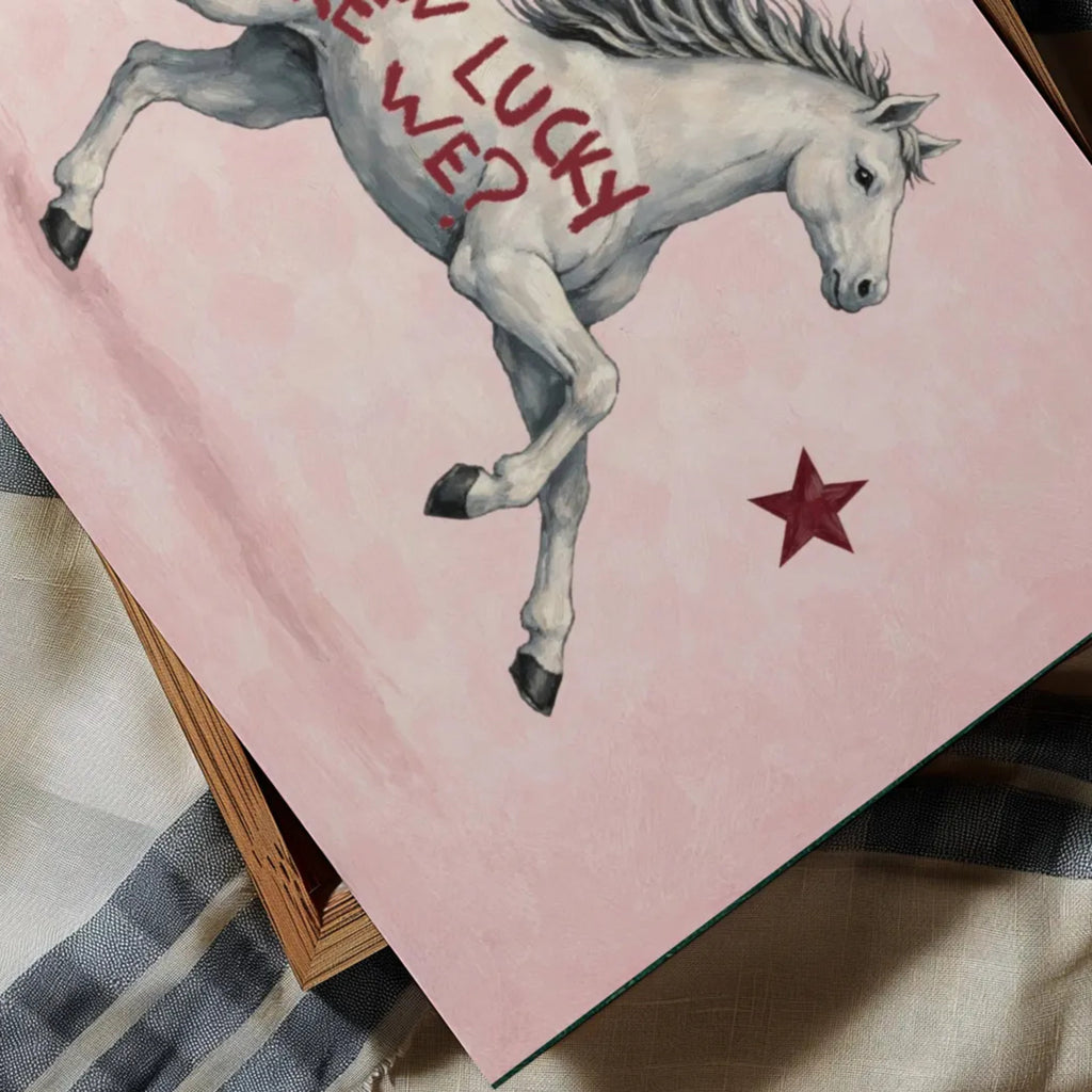 Symbolic Eclectic White Horse with red stars and handwritten quote "How Lucky Are We?" on a soft pink background. This is a hand drawn Contemporary Folk art Print Oil Painting.