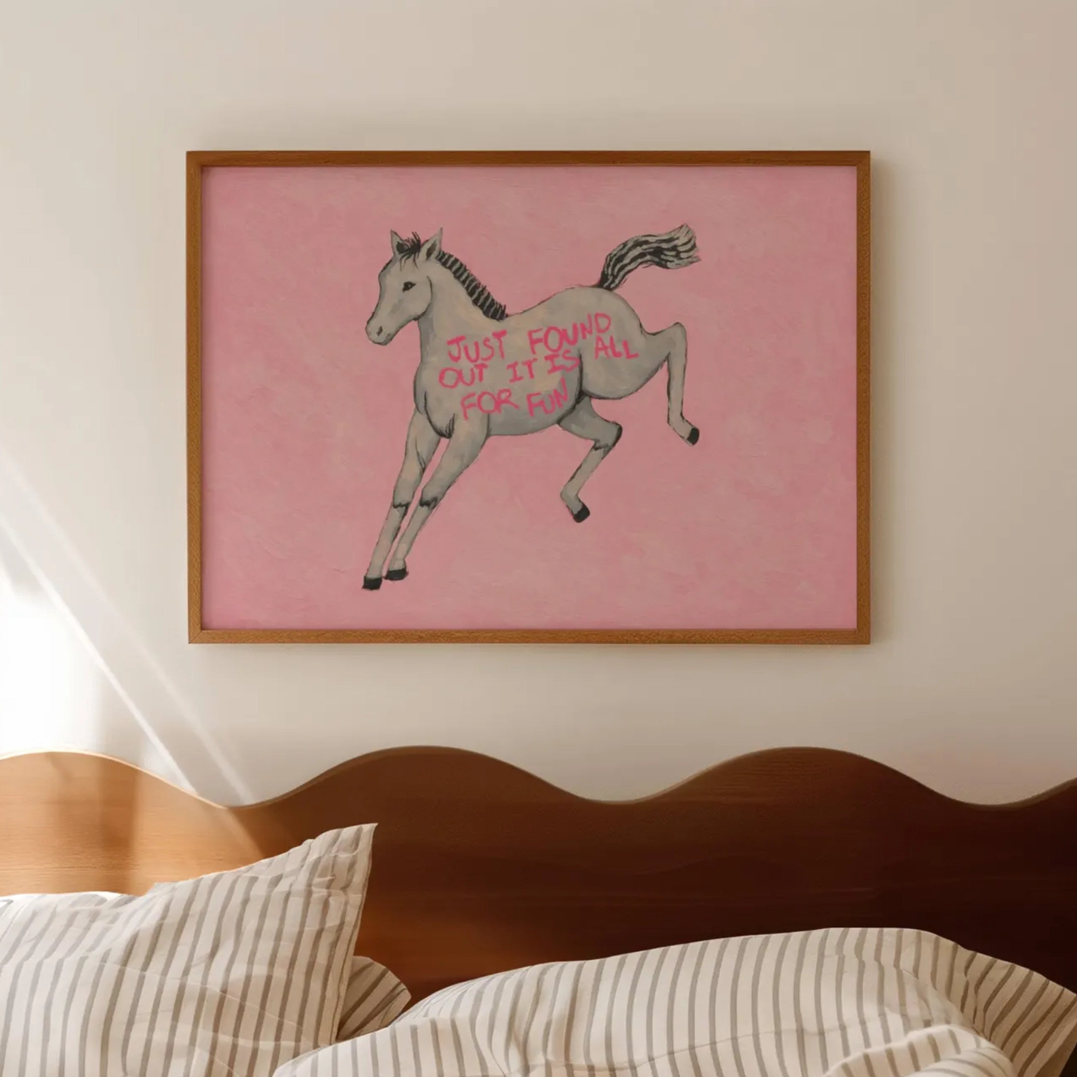 A surreal Symbolic artwork featuring a White Horse running against a pink background. The Horse has handwritten quote "Just Found Out It Is All For Fun". This is a hand drawn Eclectic Contemporary Folk art Print Oil Painting.