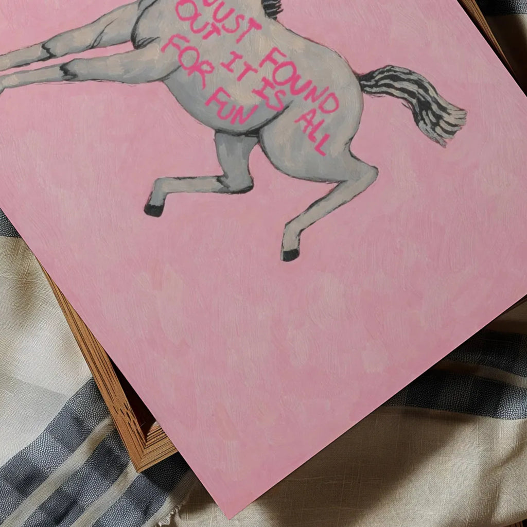 A surreal Symbolic artwork featuring a White Horse running against a pink background. The Horse has handwritten quote "Just Found Out It Is All For Fun". This is a hand drawn Eclectic Contemporary Folk art Print Oil Painting.
