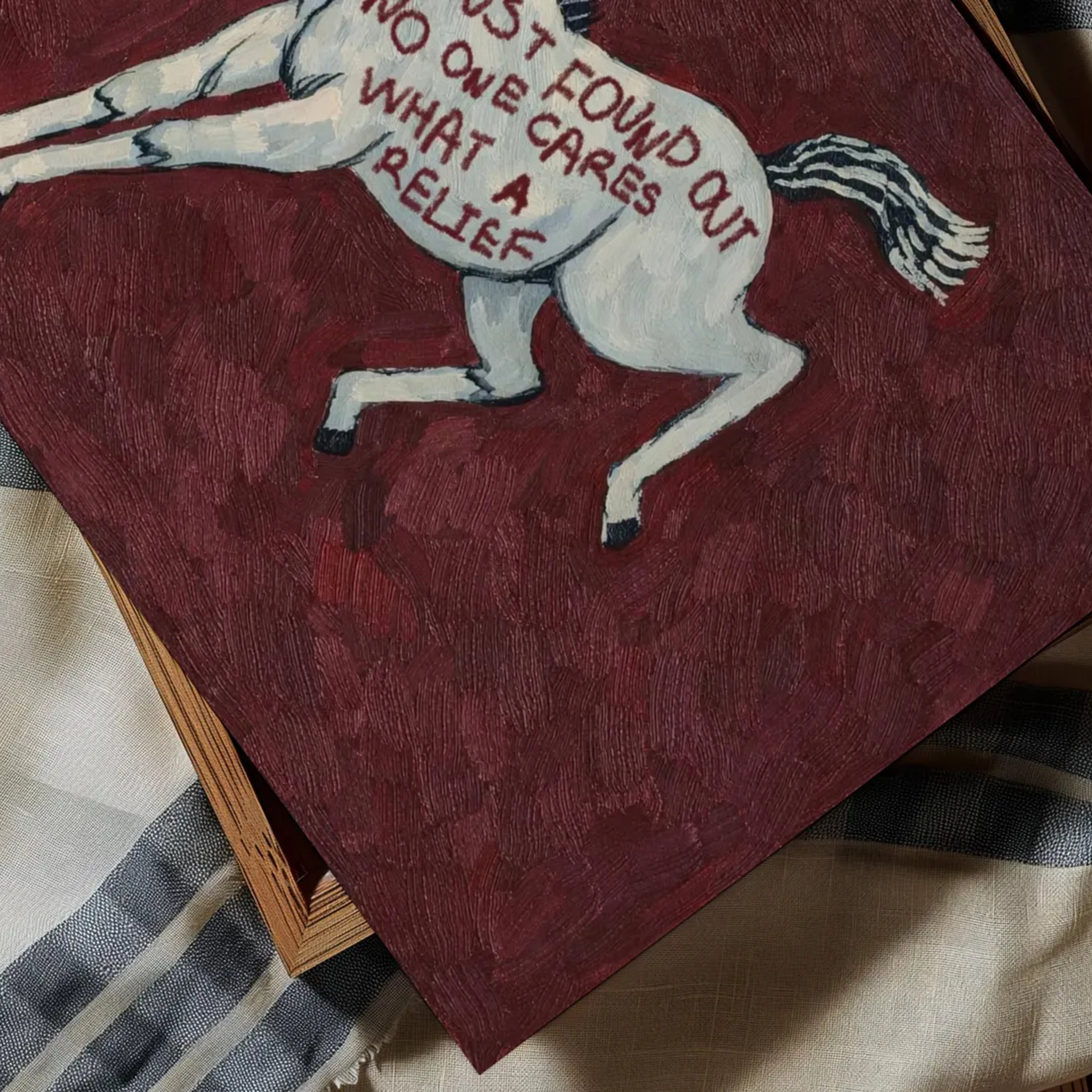 A surreal Symbolic artwork featuring a White Horse running against a burgundy background. The Horse has handwritten quote "Just Found Out No One Cares What A Relief". This is a hand drawn Eclectic Contemporary Folk art Print Oil Painting.