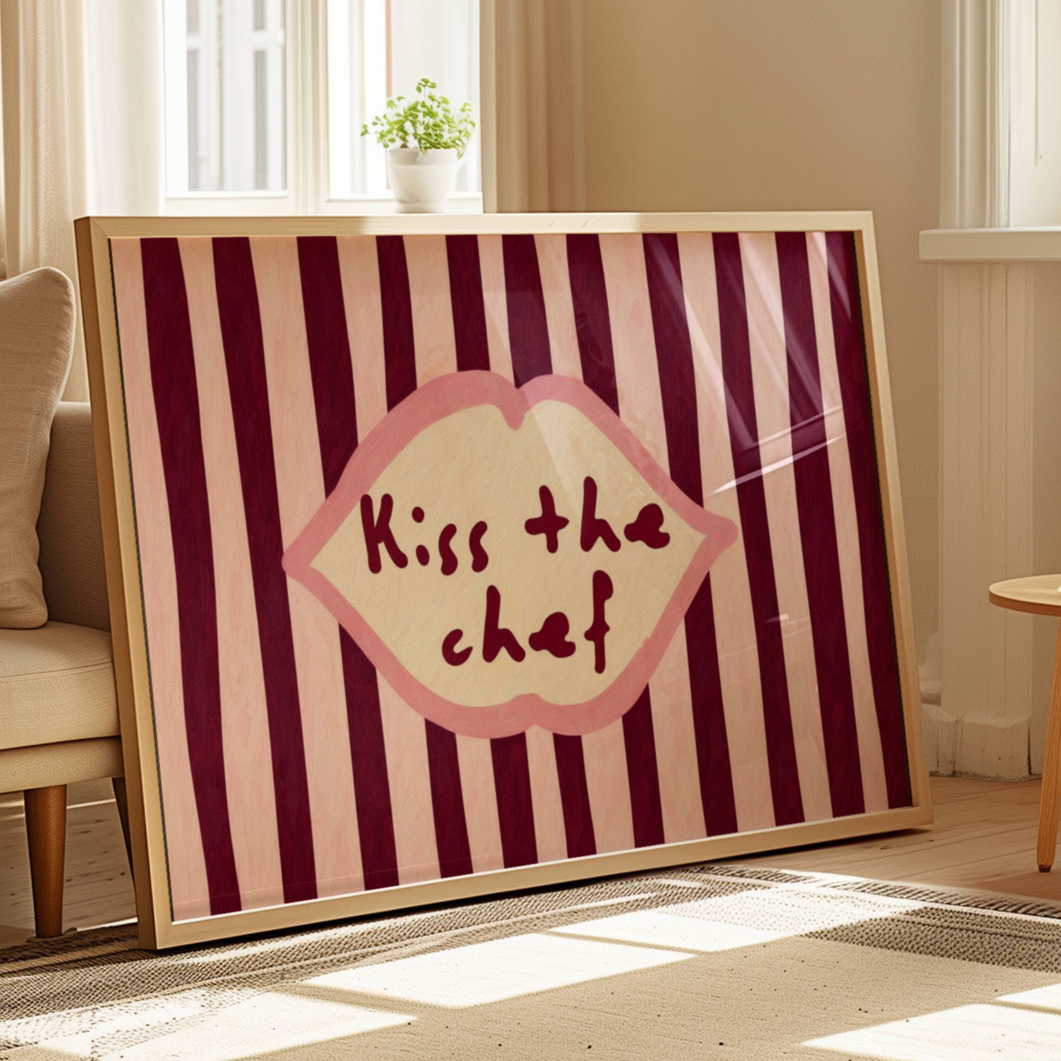 Playful Kitchen Funny Typography wall art with Handwritten quote "Kiss the chef" on a retro striped background in ruby pink tones with lips motif. This is a hand drawn Oil Painting kitchen art Print decor.