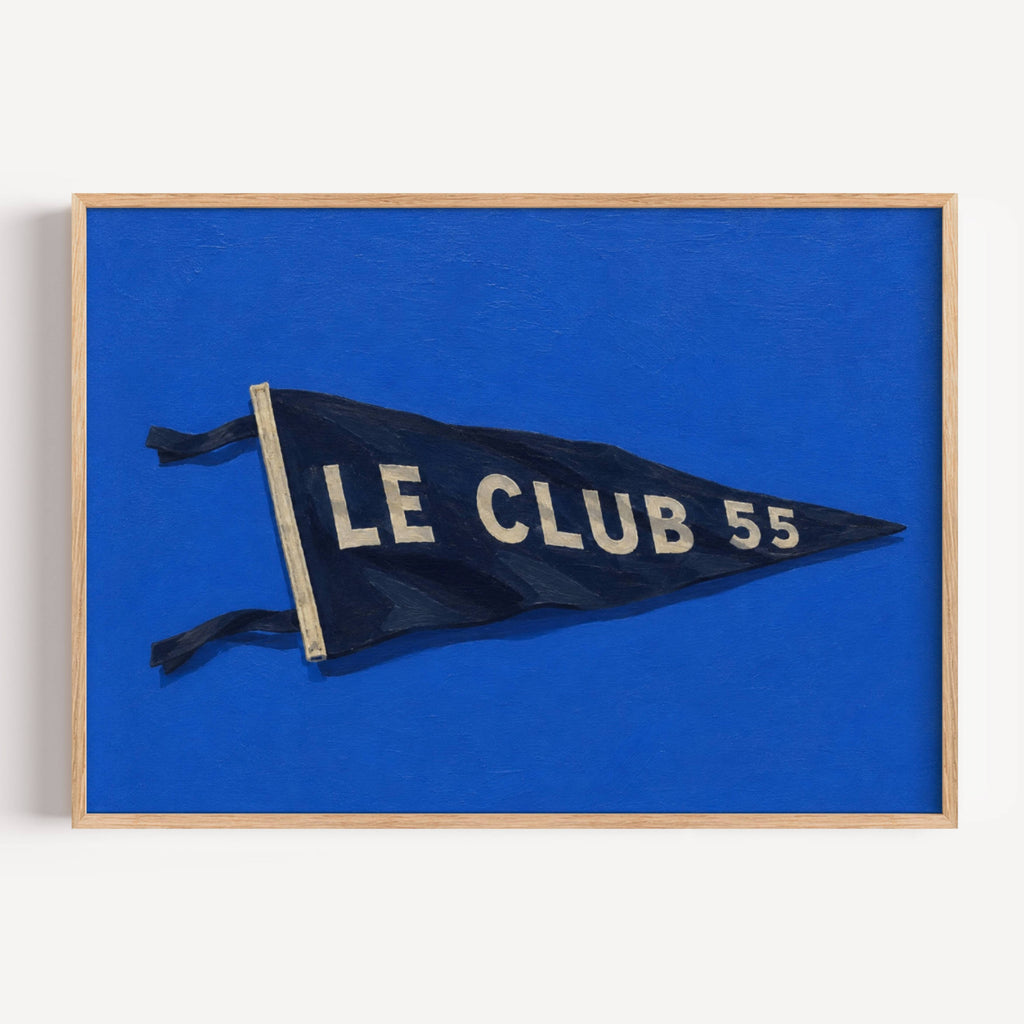 Inspired by the effortless spirit of the French Riviera, Le Club 55 captures the nostalgia of endless summers, salt air and afternoons that seem to stretch forever. Featuring a hand-painted yacht club pennant against an electric cobalt blue background, the artwork balances bold colour with quiet simplicity, bringing a refined coastal character. blends vintage sailing culture with contemporary interiors, making it equally at home in beach houses, modern living rooms, holiday homes or gallery walls. The deep 