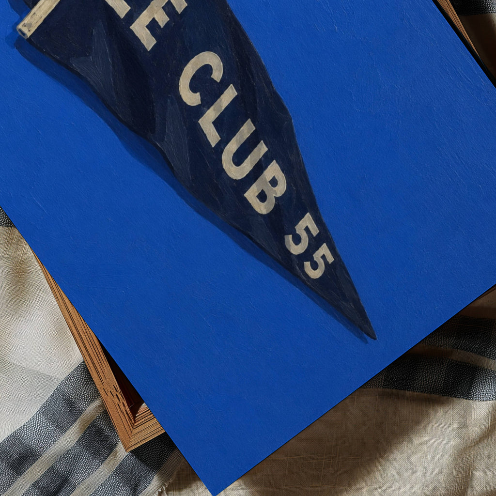 Inspired by the effortless spirit of the French Riviera, Le Club 55 captures the nostalgia of endless summers, salt air and afternoons that seem to stretch forever. Featuring a hand-painted yacht club pennant against an electric cobalt blue background, the artwork balances bold colour with quiet simplicity, bringing a refined coastal character. blends vintage sailing culture with contemporary interiors, making it equally at home in beach houses, modern living rooms, holiday homes or gallery walls. The deep 