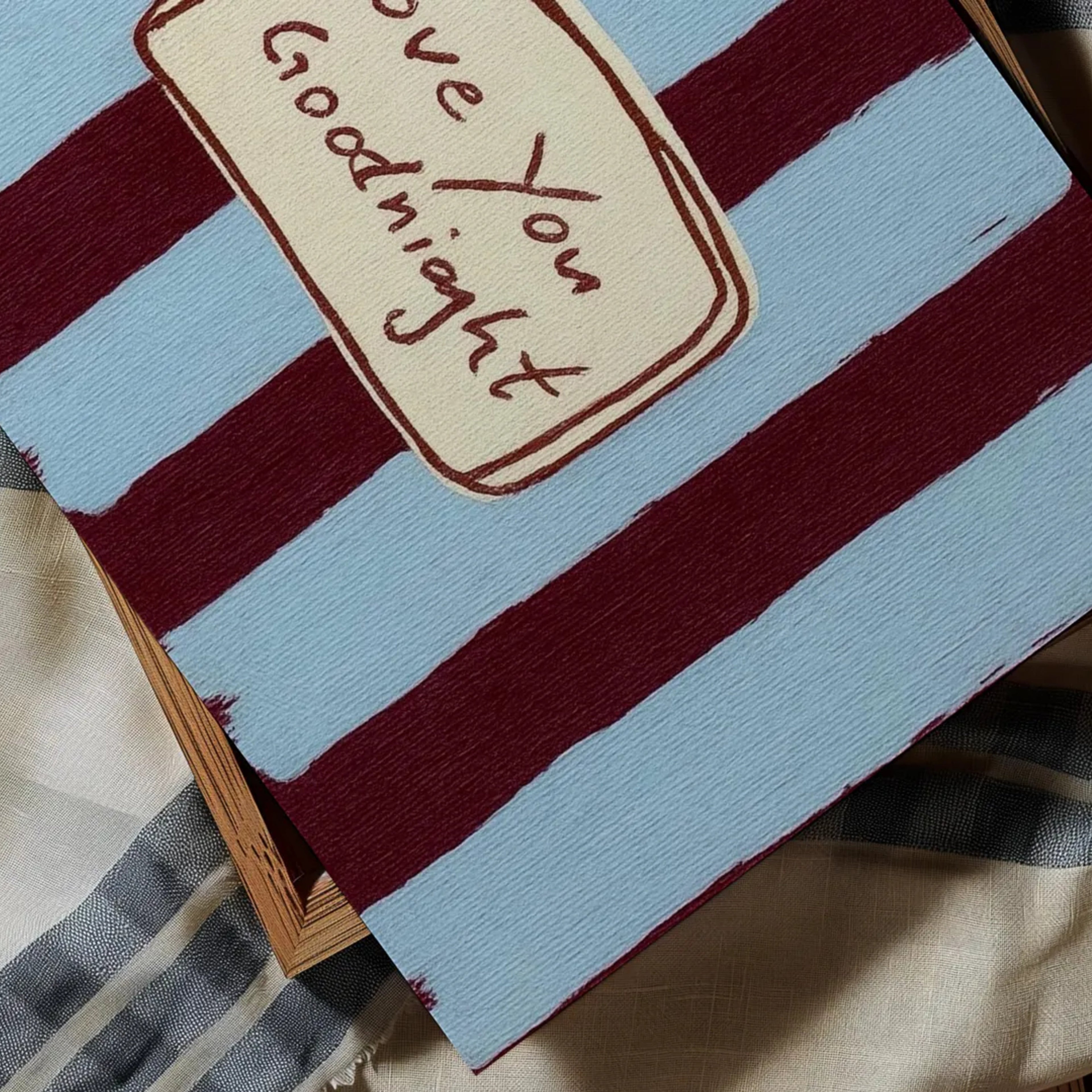 hand drawn Playful typography print with the phrase "Love You Goodnight" on a retro burgundy blue striped background, on textured oil painting canva. This is a hand drawn trendy typography wall art print ideal for bedrooms, dorm room decor, gallery walls and playful interiors.