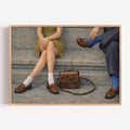 Meet me at the pavement is a hand painted Contemporary and figurative wall art of two seated figures, vintage shoes and a handbag in a nostalgic mid century inspired scene, against a grey background with expressive painterly texture. Minimalist Mid century modern oil painting with loafers in cinematic nostalgia composition.