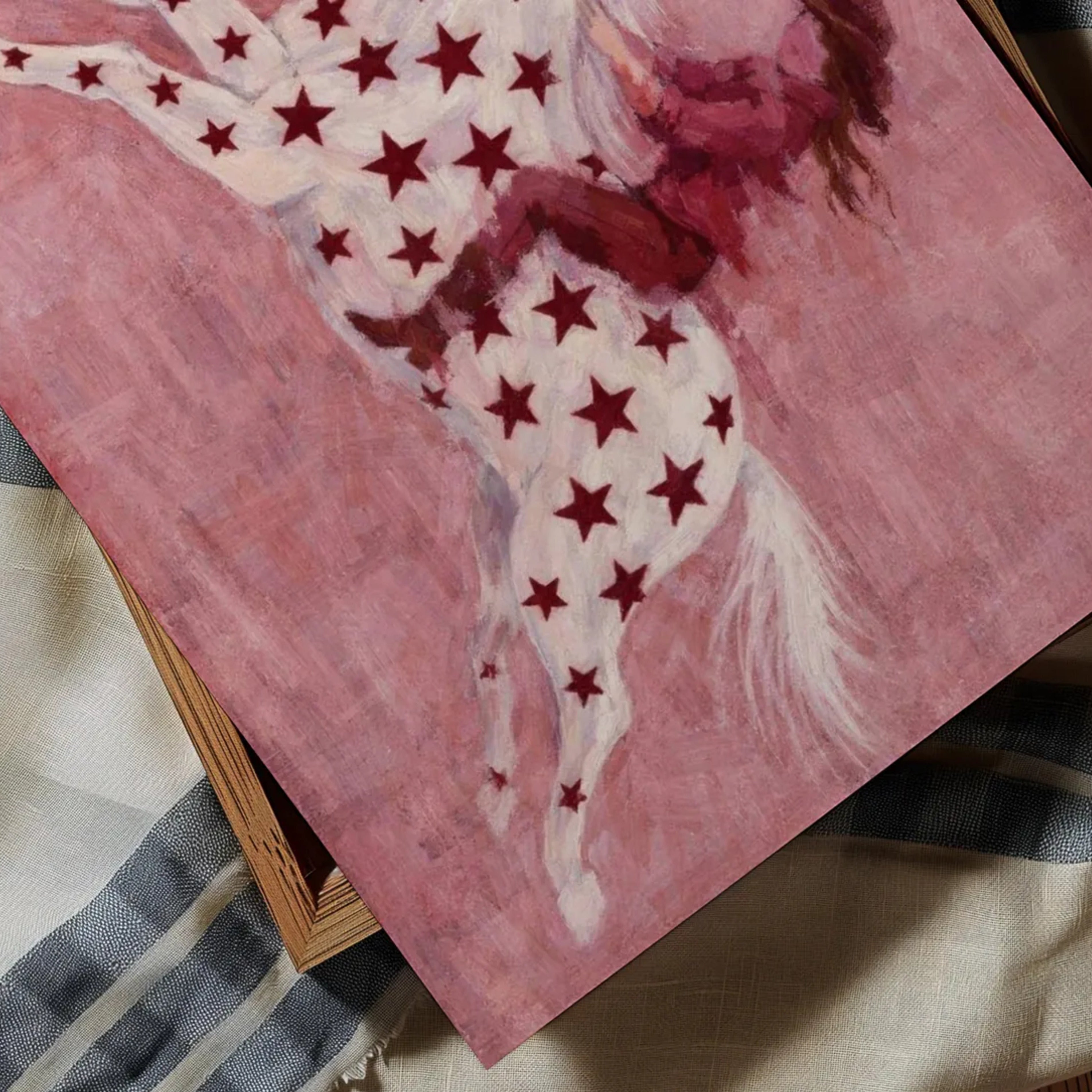 contemporary western folk style artwork of a cowgirl woman riding a star patterned horse with red burgundy stars on a pink background. hand drawn painterly effect