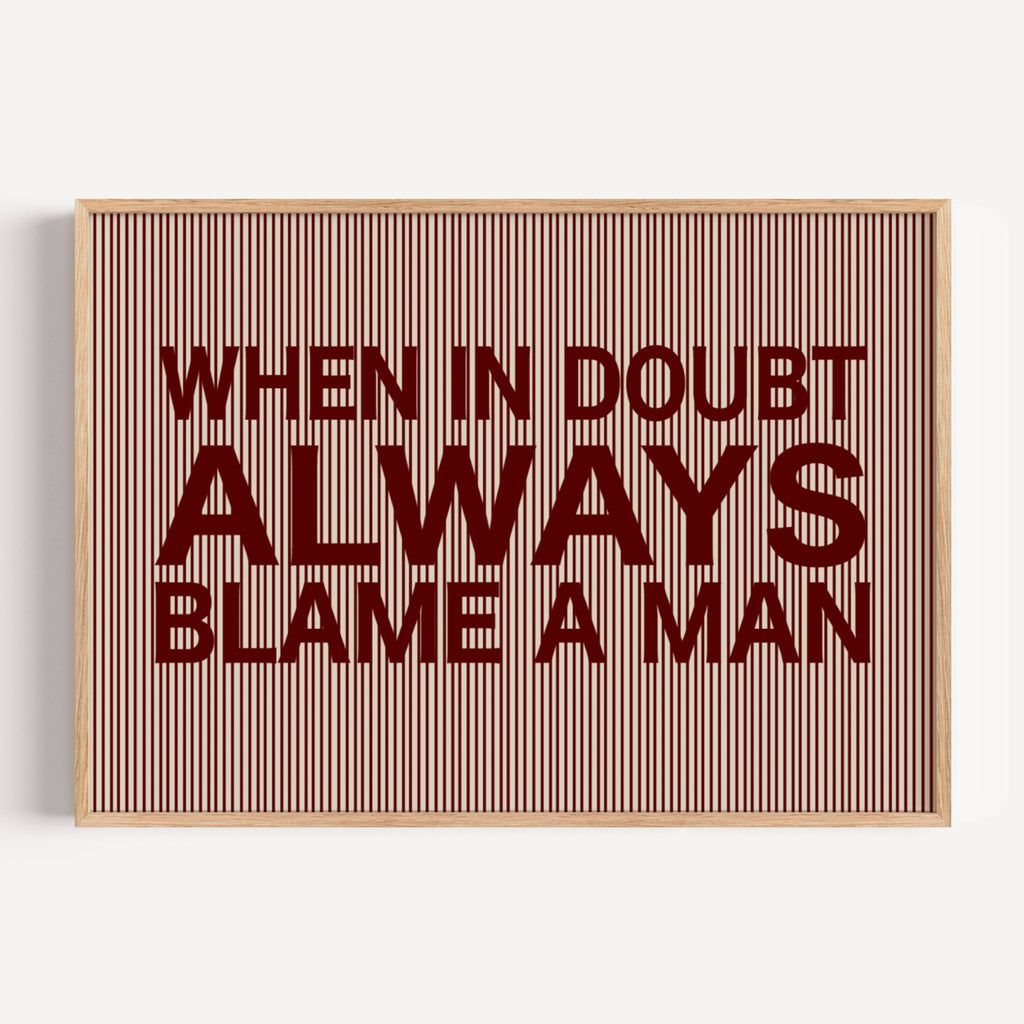 hand drawn Playful Funny typography print with the phrase "WHEN IN DOUBT ALWAYS BLAME A MAN" in a retro striped burgundy ruby canva. This is a trendy funny typography wall art print ideal for above bed, bedrooms, dorm room decor, living rooms and kitchens, gallery walls and playful interiors. The perfect Cool Girl Apartment decor