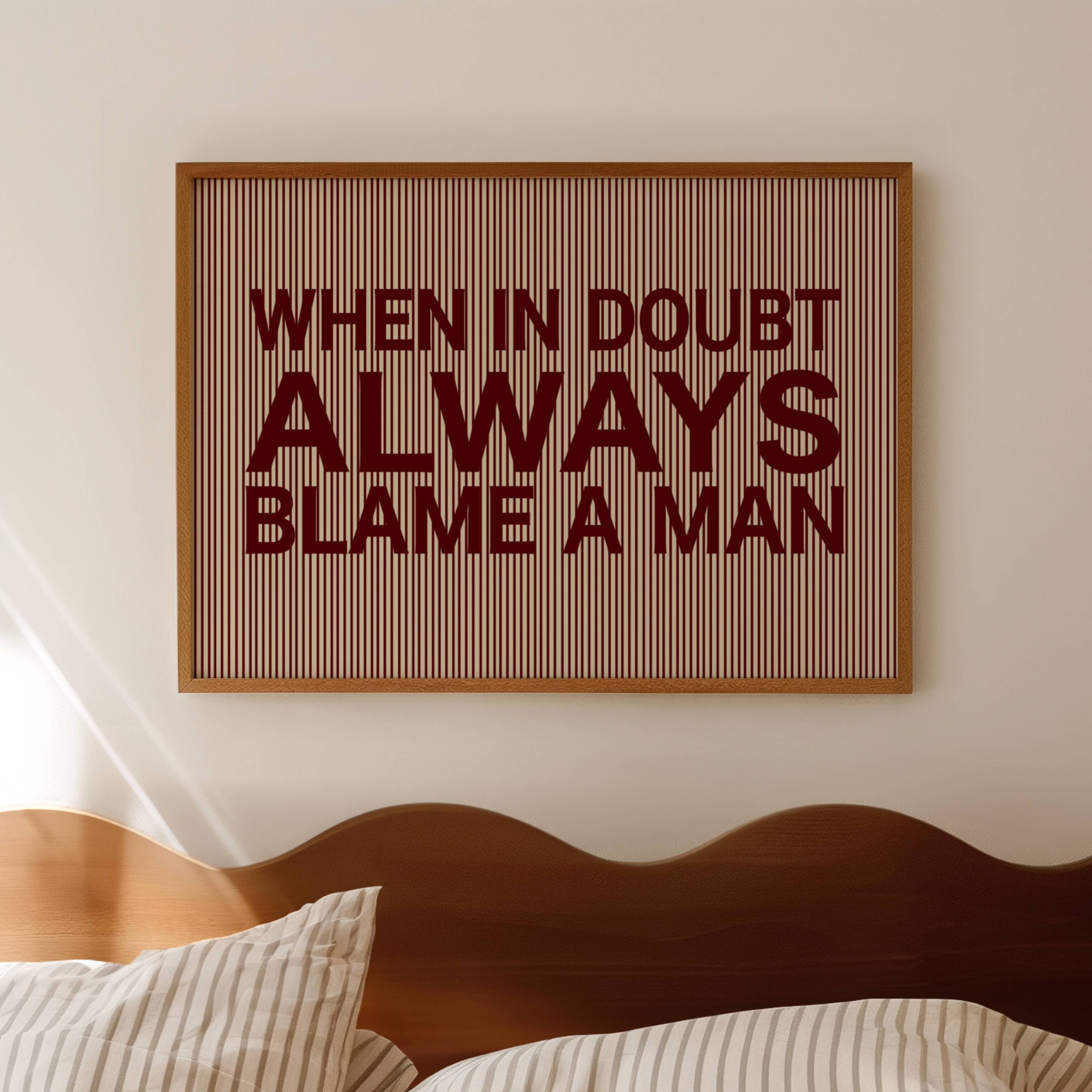 hand drawn Playful Funny typography print with the phrase "WHEN IN DOUBT ALWAYS BLAME A MAN" in a retro striped burgundy ruby canva. This is a trendy funny typography wall art print ideal for above bed, bedrooms, dorm room decor, living rooms and kitchens, gallery walls and playful interiors. The perfect Cool Girl Apartment decor