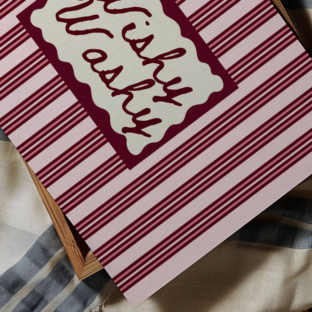 Wishy Washy is a whimsical Retro typography art print designed to bring humour, colour and personality into your bathroom and laundry room. Featuring vintage-inspired striped patterns and hand-lettered typography, this artwork captures the nostalgic charm of classic bath-time phrases while adding a playful decorative touch to modern interiors. this is a hand drawn Retro quote wall art featuring, ideal for bathrooms, laundry room decor, and cheeky playful interiors. pink ruby