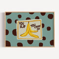Funny Playful Hand drawn Kitchen wall art with a banana peel illustration and the phrase "You Slip You Carry On" on a blue polka dot background. This is a hand drawn Food Oil Painting kitchen and bar cart art Print decor for playful kitchens, dining spaces and eclectic interiors.