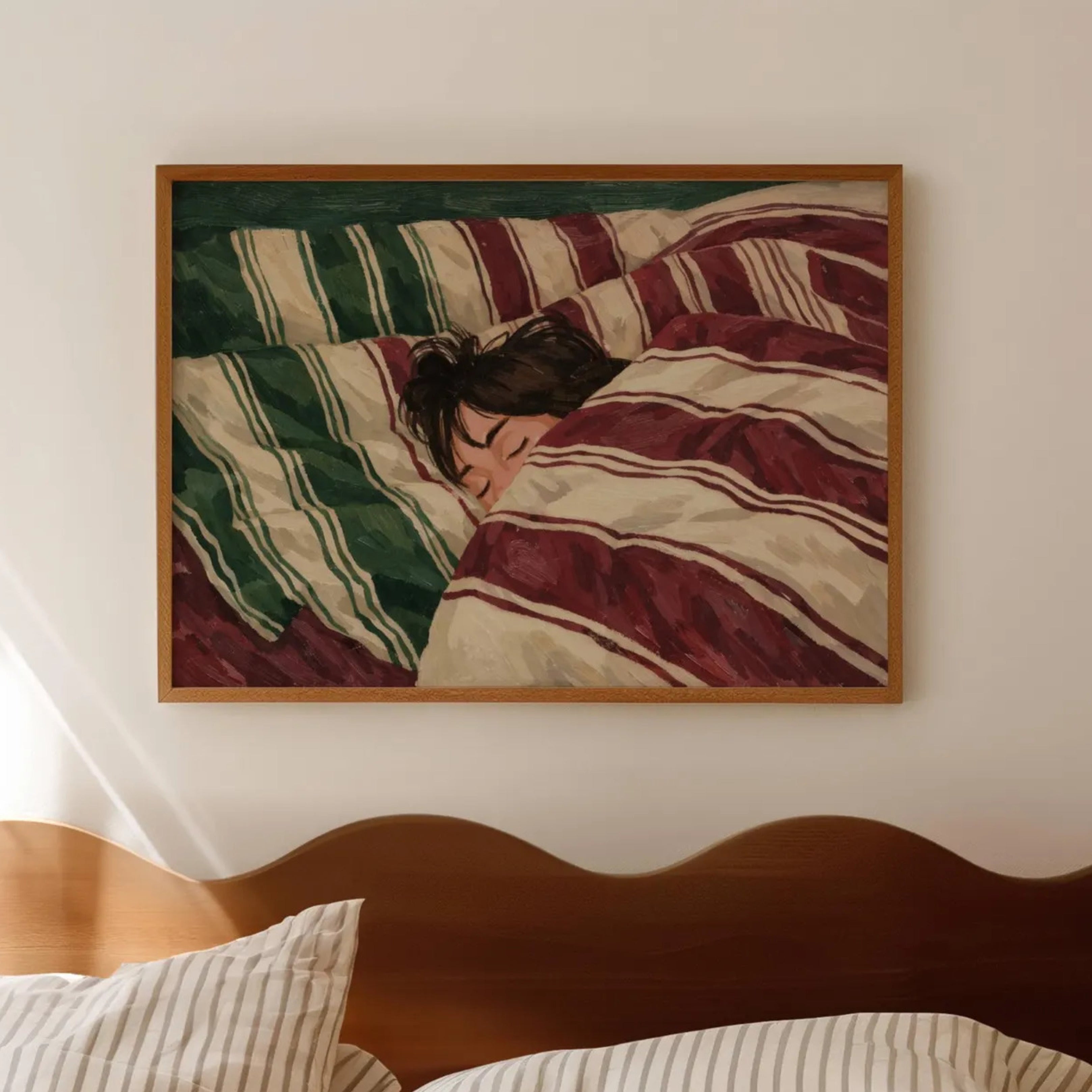 against all productivity is a hand painted wall art print of a sleeping womam in striped bedding, in green and burgundy tones, inspired by slow mornings and nostalgic interiors, symbolizing quiet luxury and unhurried mornings. Horizontal above bed oil painting wall art print . sunday morning aesthetic intimate wall art