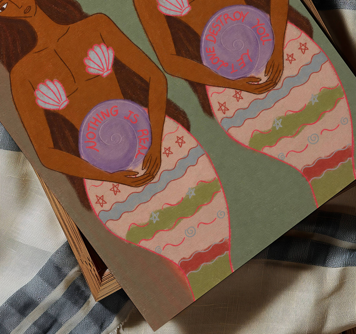 An illustrated art print featuring two stylized female figures with purple spiral symbols on their bellies, resting on a striped blanket.