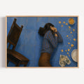 Framed artwork of a person lying on a blue floor with a chair and scattered items.