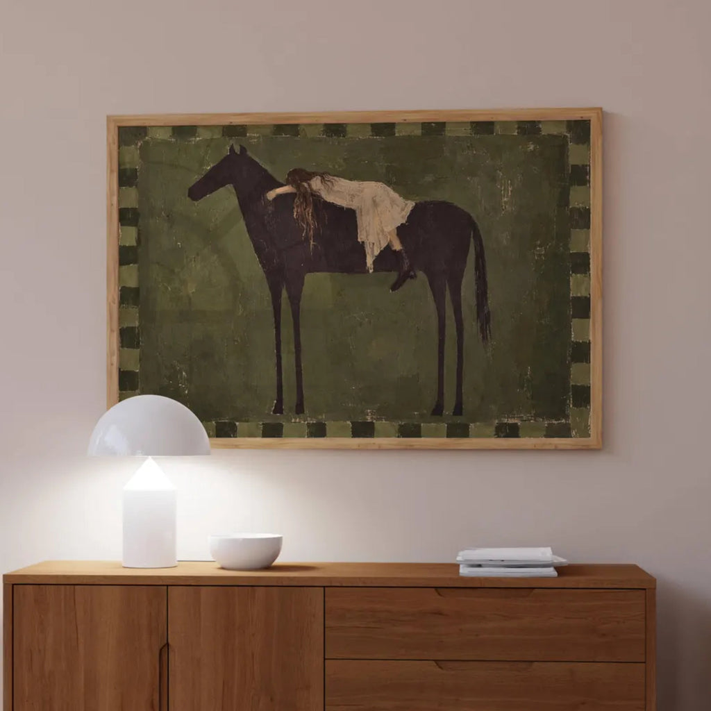 Held by the Horse is a symbolic Western Horse Artwork featuring a restiing female figure on a dark horse in earthy khaki tones