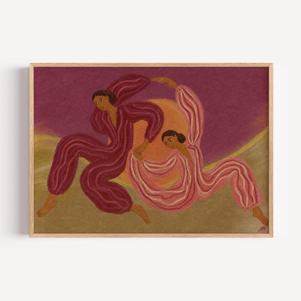 A framed art print featuring an abstract painting of two dancing figures in flowing striped garments against a purple and gold background, shown hanging on a light wall.