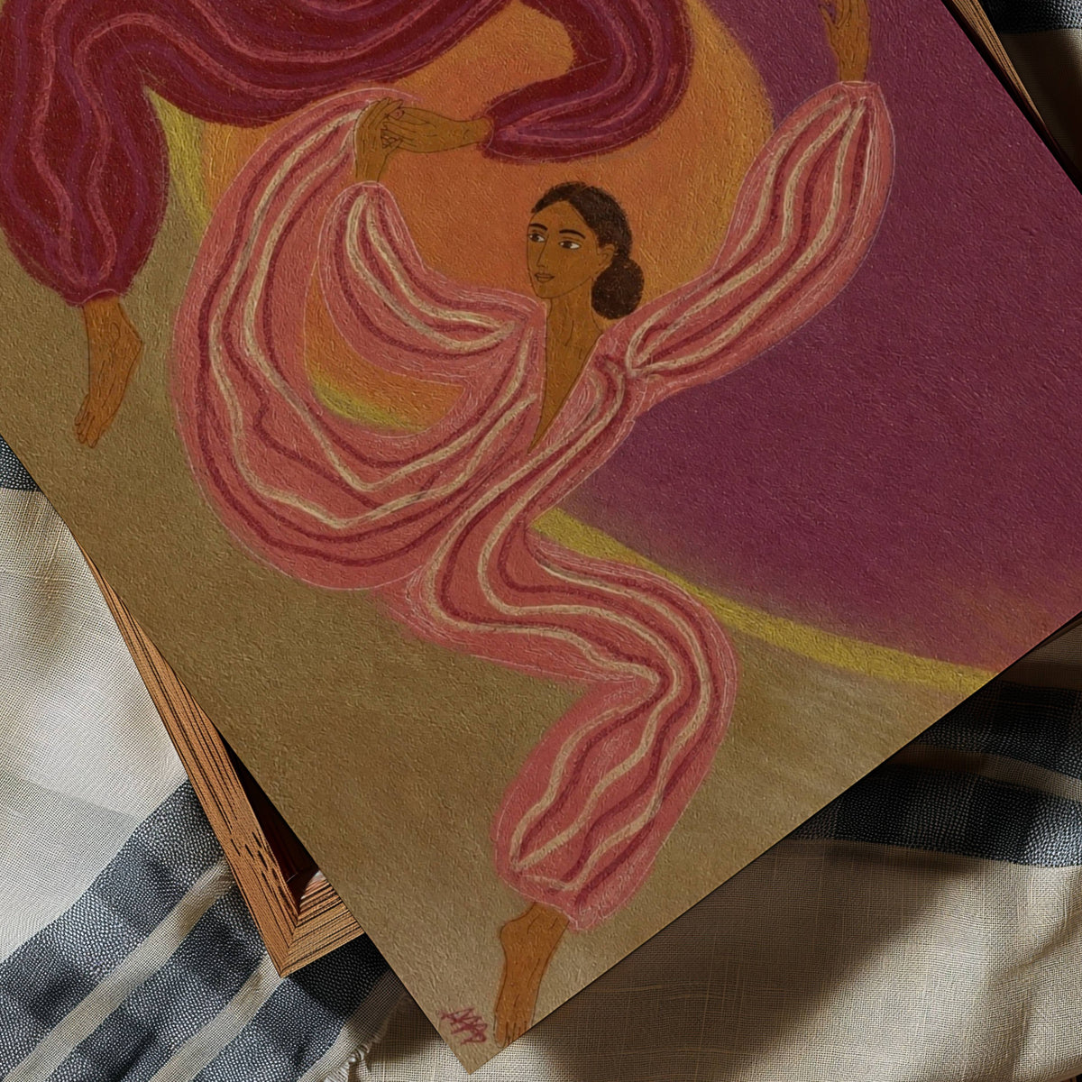 A square art print or painting depicting a stylized dancer with flowing pink and white garments against a purple and orange background, photographed at an angle on top of striped fabric.