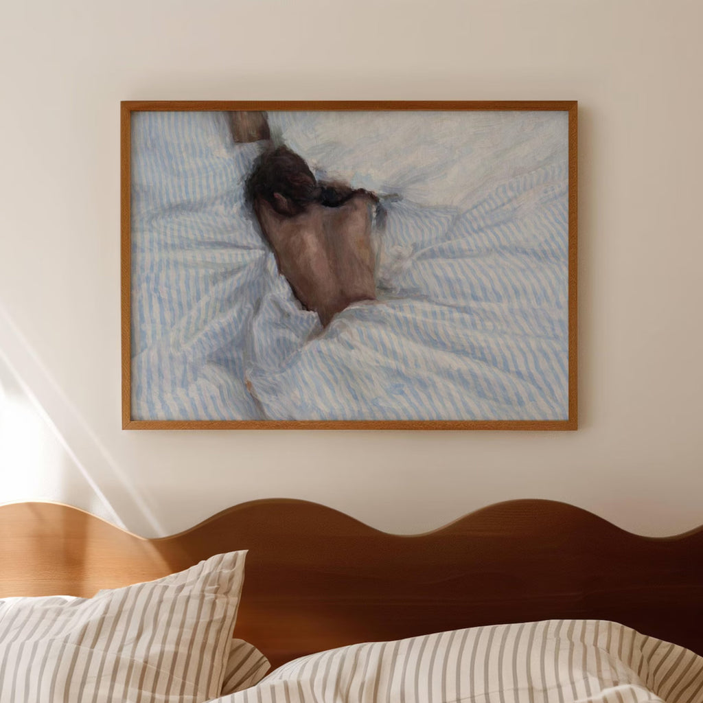 the art of staying is a hand painted wall art print of a sleeping womam in striped bedding, in light blue and butter yellow tones, inspired by slow mornings and nostalgic interiors, symbolizing quiet luxury and unhurried mornings. Horizontal above bed oil painting wall art print . sunday morning aesthetic intimate wall art