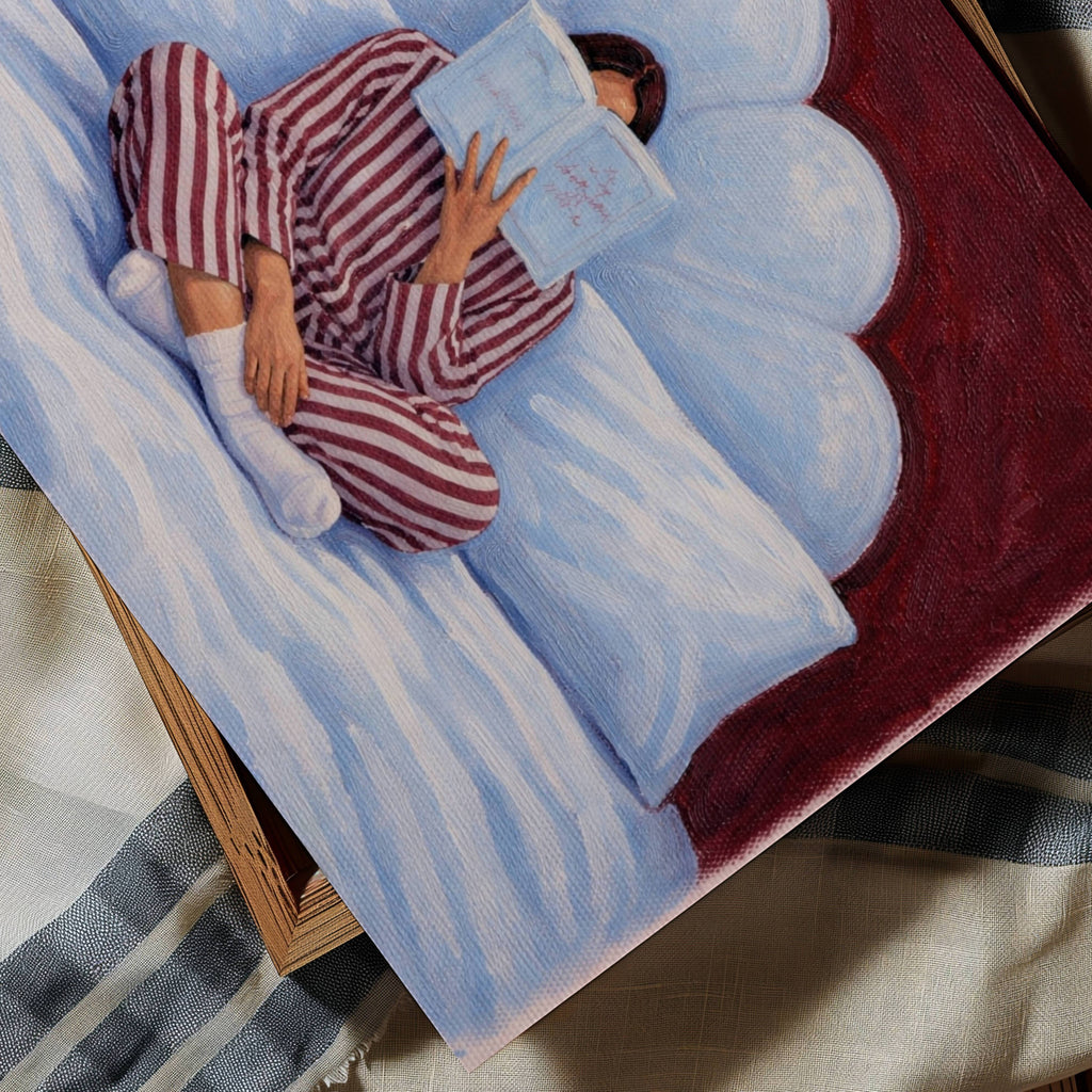 the last good habit is a hand painted wall art print of a womam reading in bed wearing her striped pyjamas, in blue and ruby tones, inspired by vintage glamour and maximalist cinematic luxury interiors, symbolizing femininity and nostalgic interiors. Horizontal above bed oil painting wall art print
