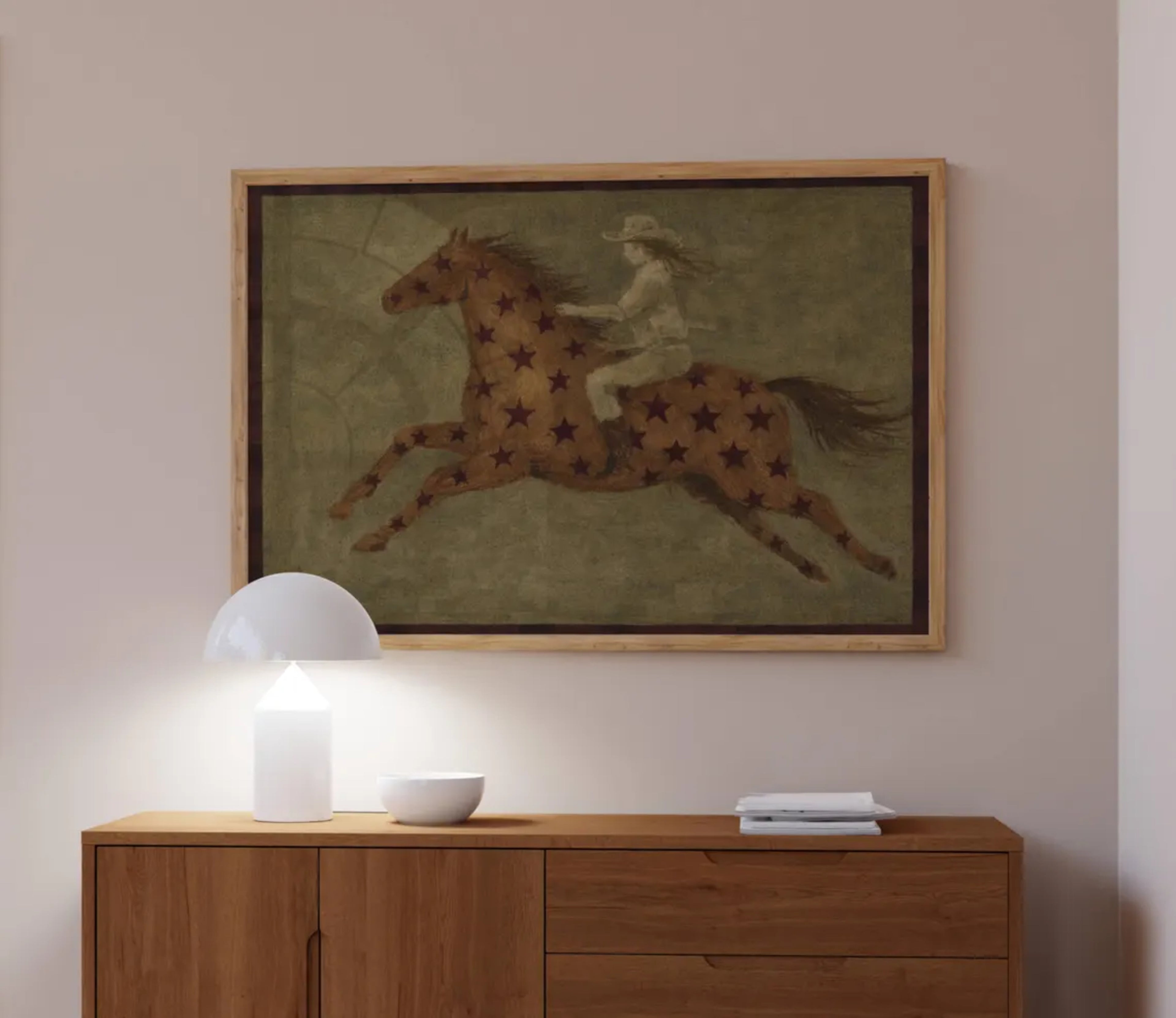 contemporary western folk style artwork of a cowgirl woman riding a star patterned horse with brown stars on a khaki background. hand drawn painterly effect