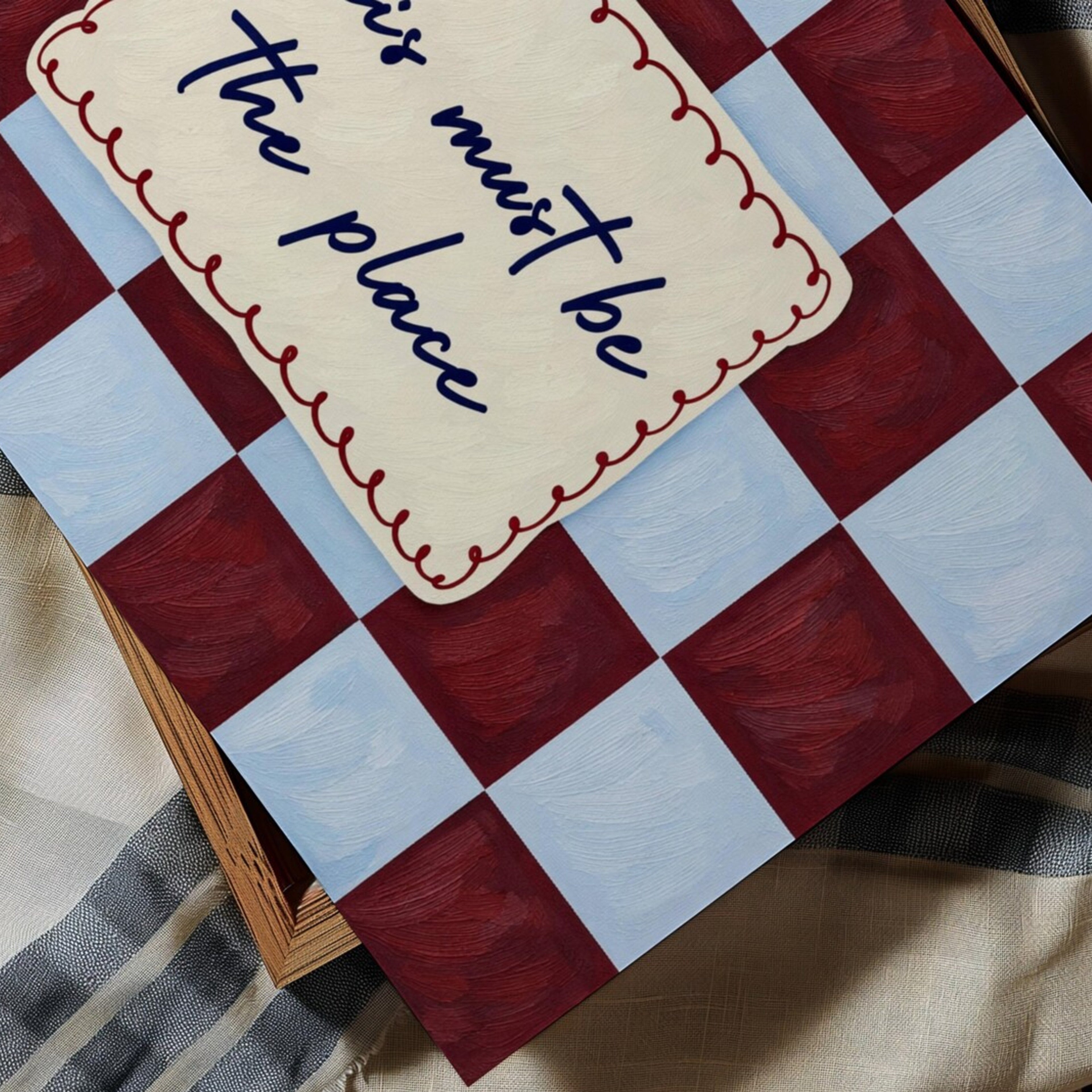 hand drawn Playful typography print with the phrase "this must be the place" in a retro checkerboard  blue and ruby burgundy, on textured oil painting canva. This is a hand drawn trendy typography ideal for above bed, bedrooms, dorm room decor, living rooms and kitchens, gallery walls and playful interiors.