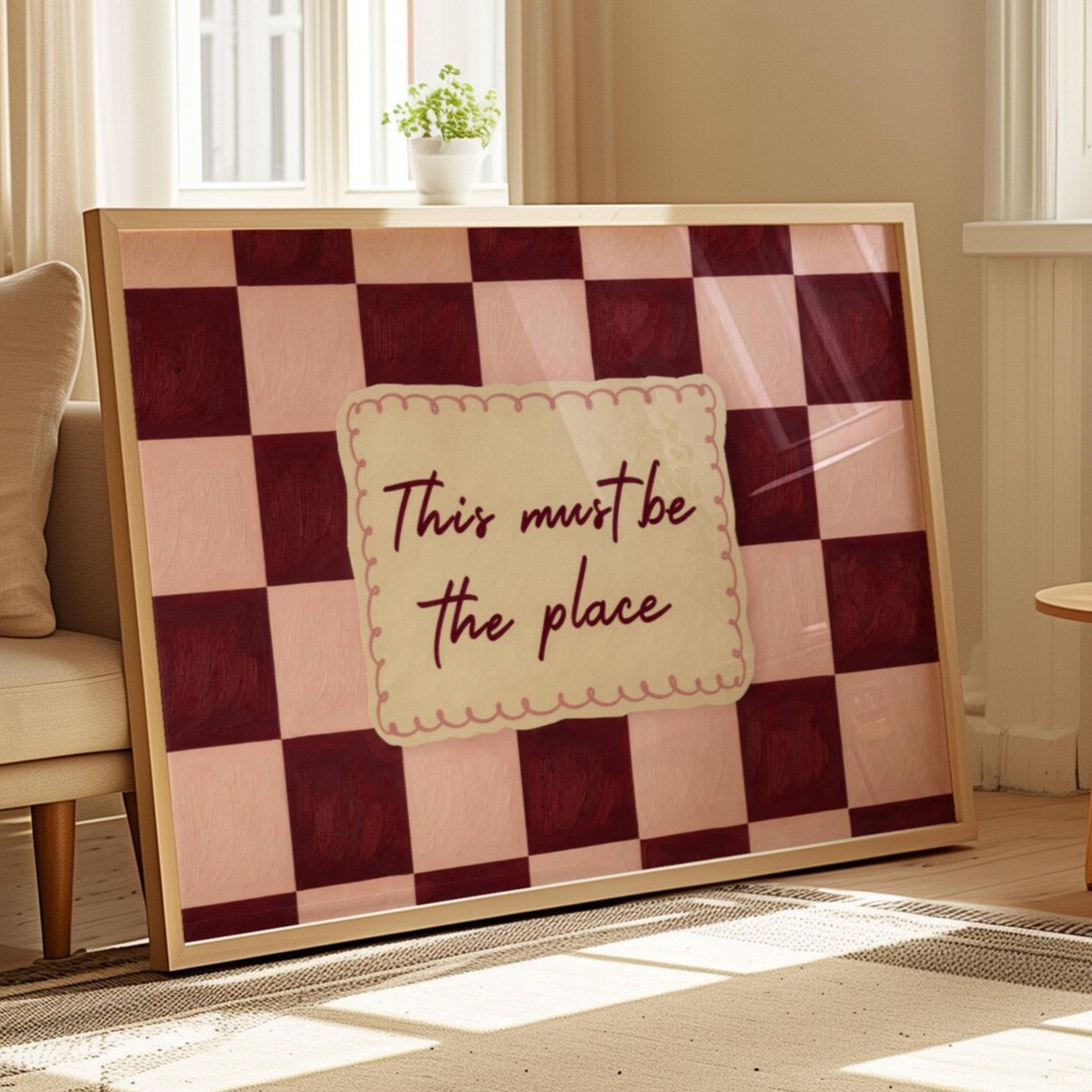 hand drawn Playful typography print with the phrase "this must be the place" in a retro checkerboard pink and ruby burgundy, on textured oil painting canva. This is a hand drawn trendy typography ideal for above bed, bedrooms, dorm room decor, living rooms and kitchens, gallery walls and playful interiors.