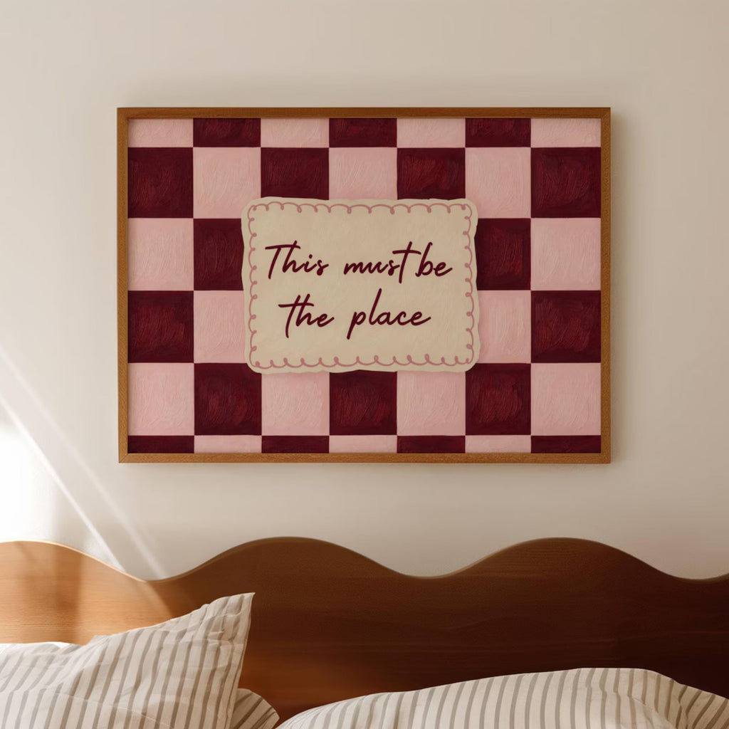 hand drawn Playful typography print with the phrase "this must be the place" in a retro checkerboard pink and ruby burgundy, on textured oil painting canva. This is a hand drawn trendy typography ideal for above bed, bedrooms, dorm room decor, living rooms and kitchens, gallery walls and playful interiors.